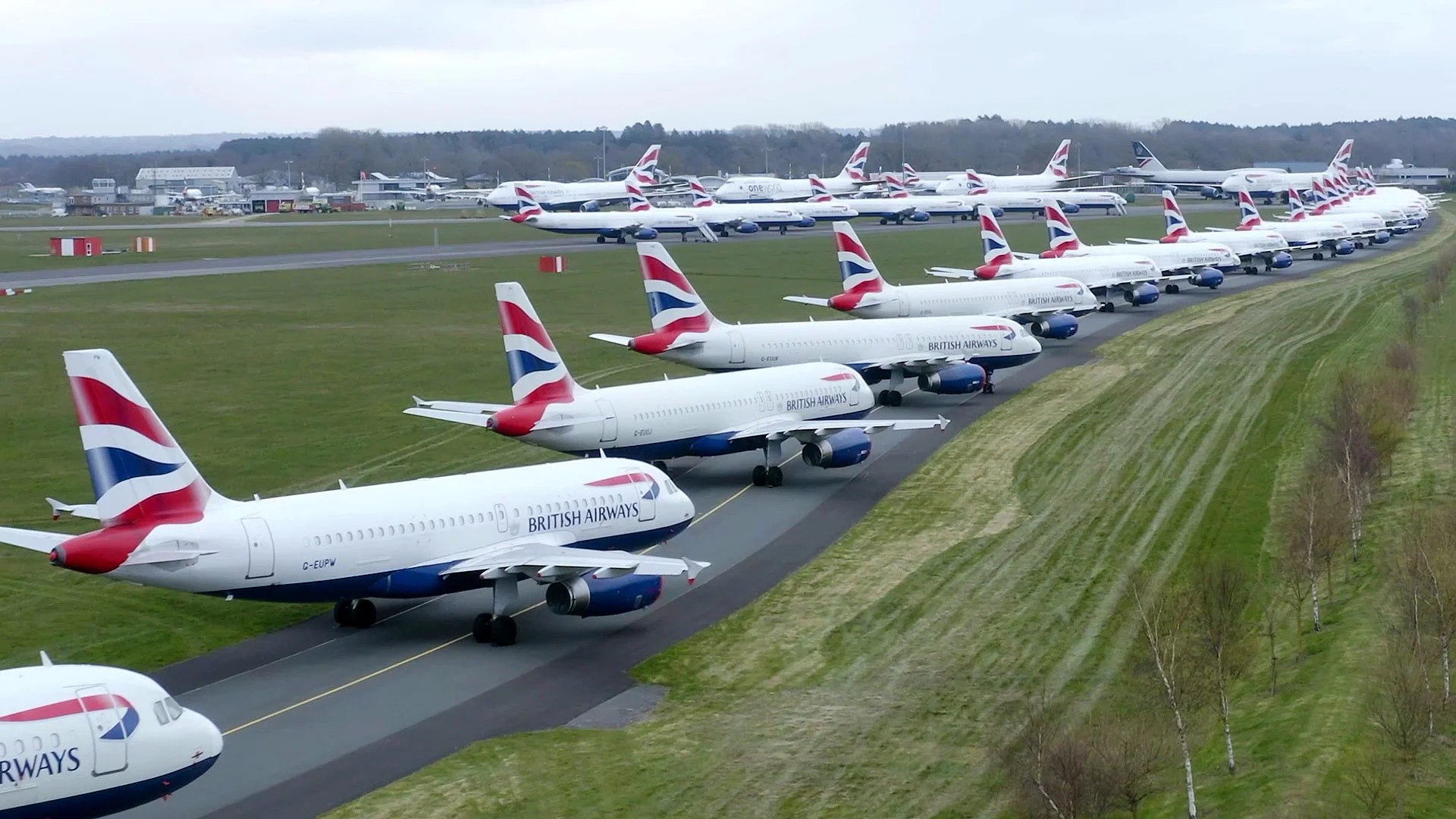 Aerial drone view of Bournemouth Airport, showing grounded aircraft, runways and aviation infrastructure within the restricted airport environment.