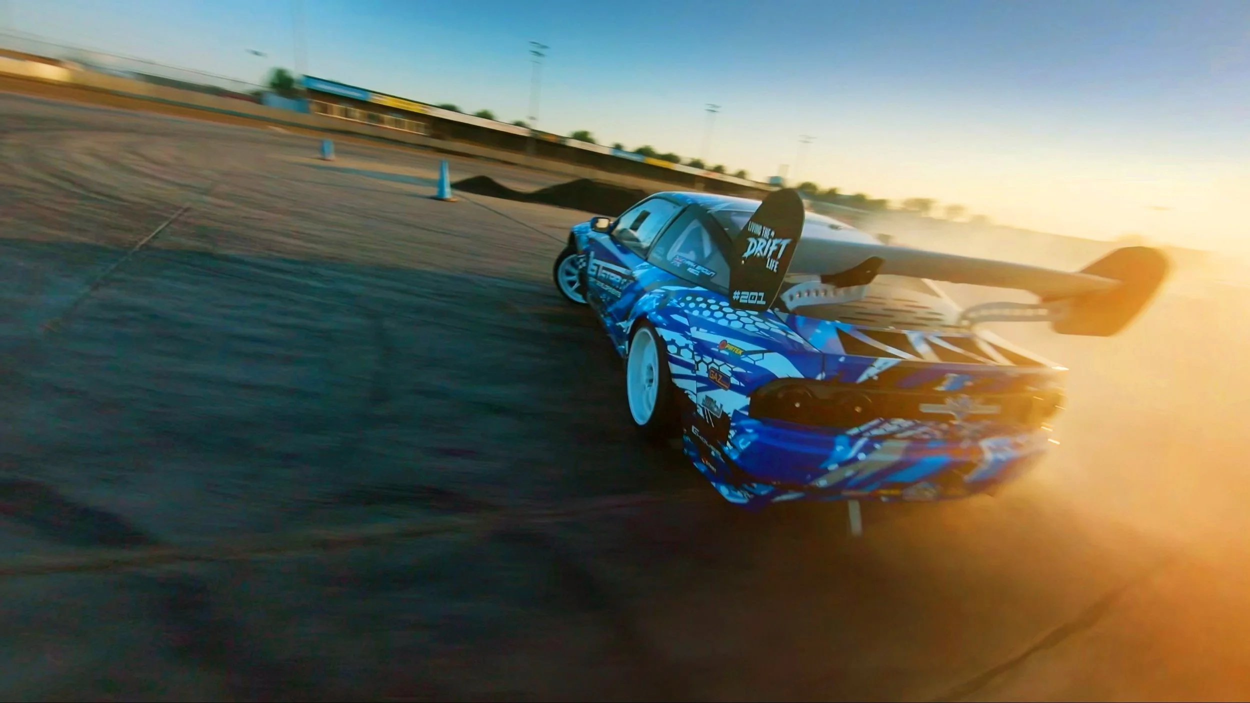 FPV drone view of a drift car at King’s Lynn, capturing high-speed motorsport action, tyre smoke and close-proximity vehicle tracking on the circuit.