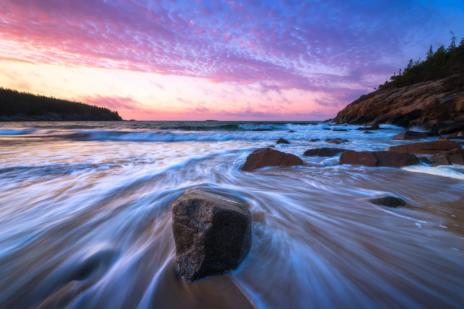 Crashing waves at sunrise on Acadia National Park's Sand Beach