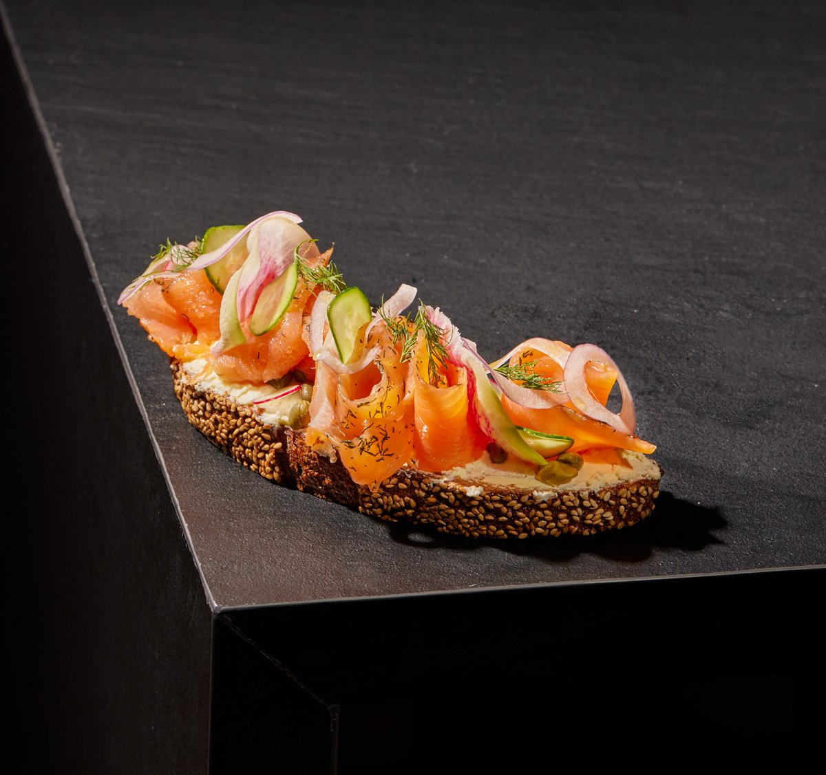  Salmon Toast with house-made gravlax, bellwether fromage blanc, cucumber, shaved onion, dill, and capers 