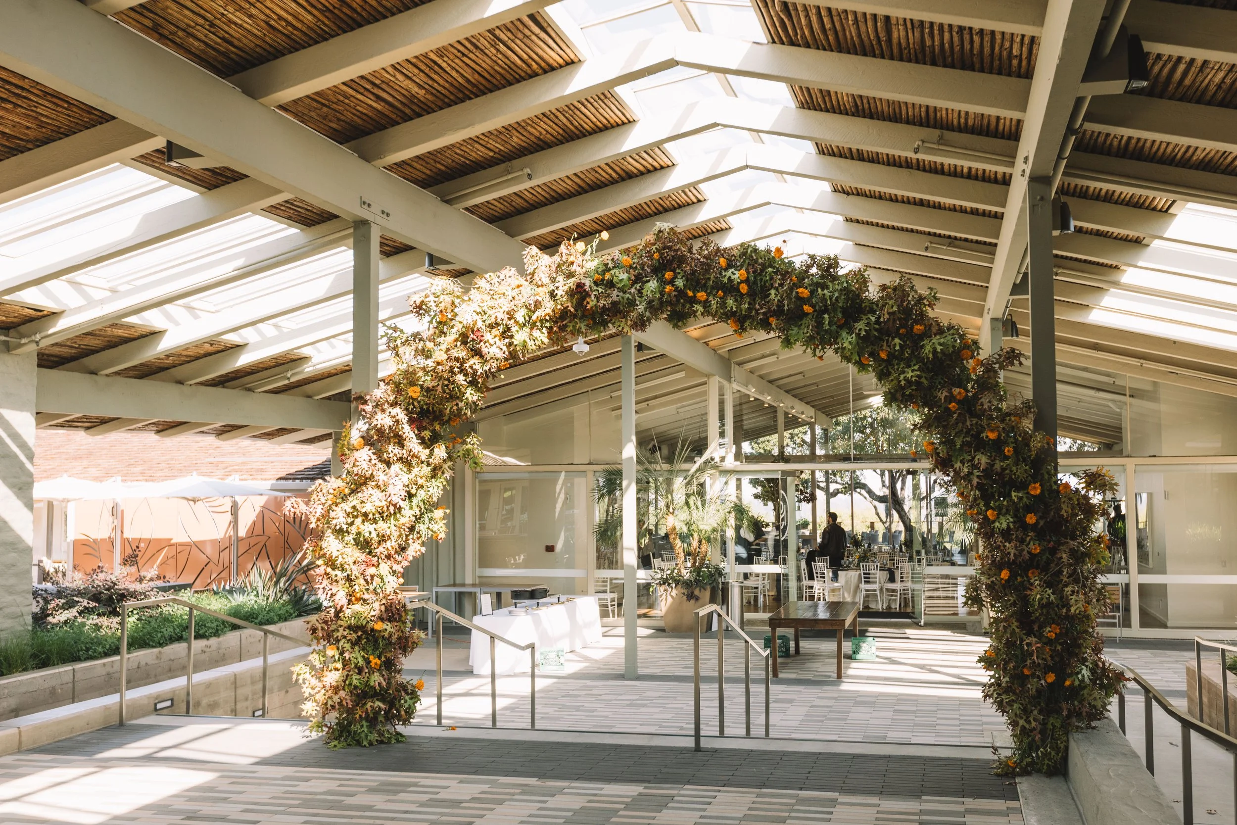 Large flower arch decorating the entrance to The Quad Conference Center.