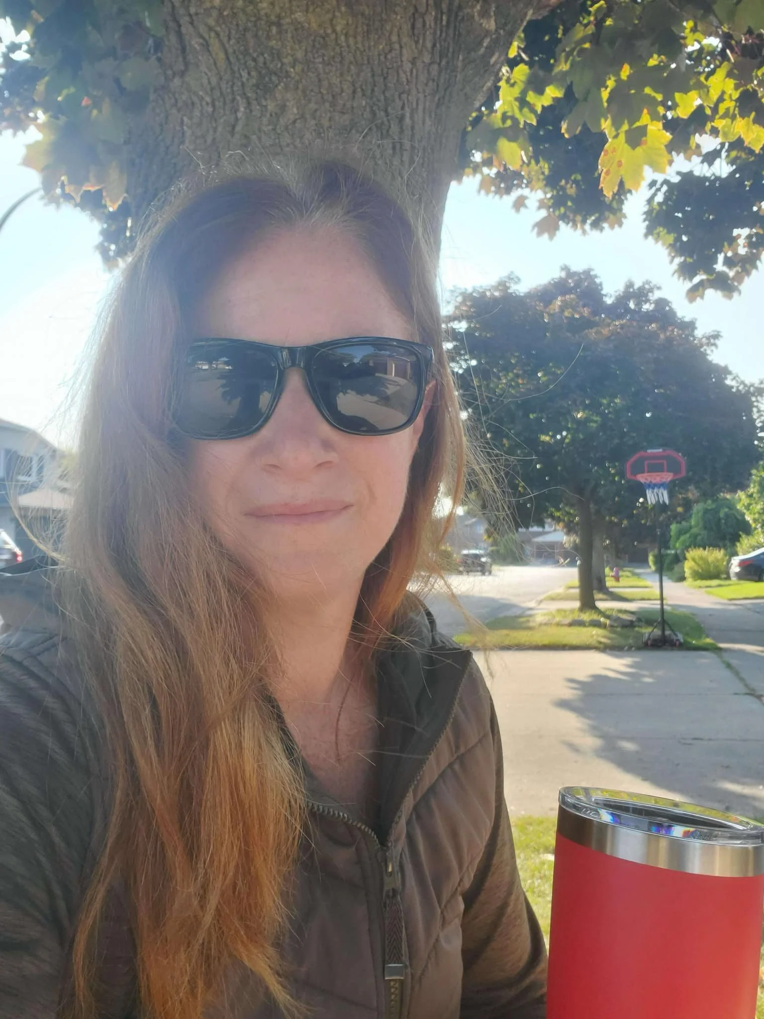 Photo credit: Jodi Laking; photo of Jodi outside, wearing sunglasses and a green jacket