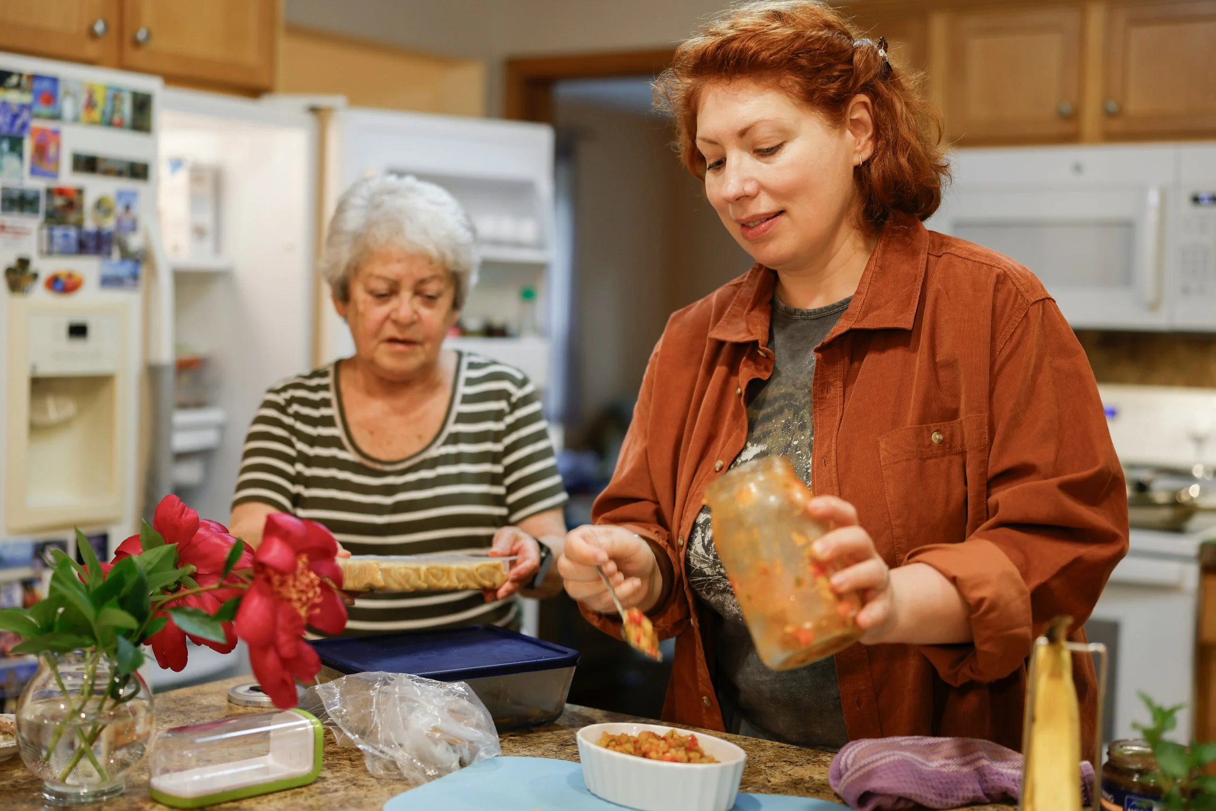 Mother and daughter in the kitchen preparing lunch; image used to promote workshop: "The Caregiving CEO: Structure for Business and Family"
