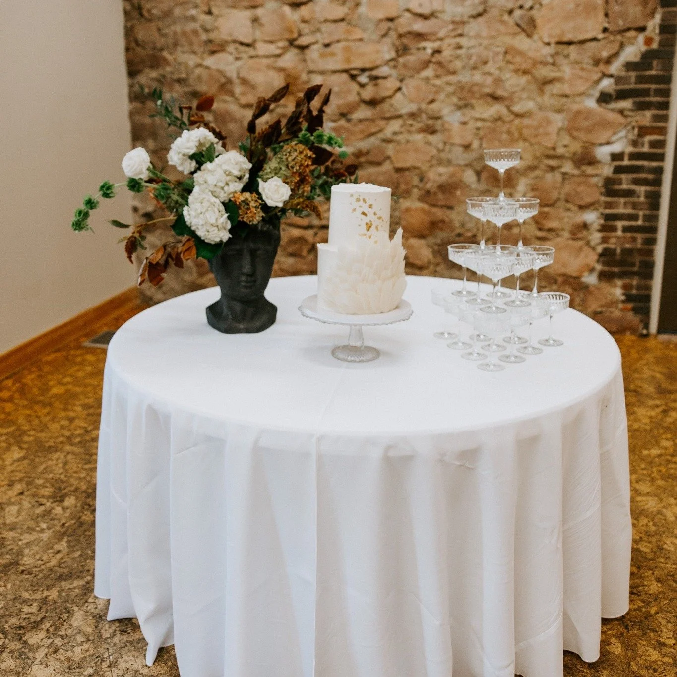 Sometimes the simplest details make the biggest impact.

A classic linen, glass cake stand, and champagne tower create an elevated moment for your reception &mdash; perfect for celebrating the sweetest part of the night.

As we celebrate Year Ten of 