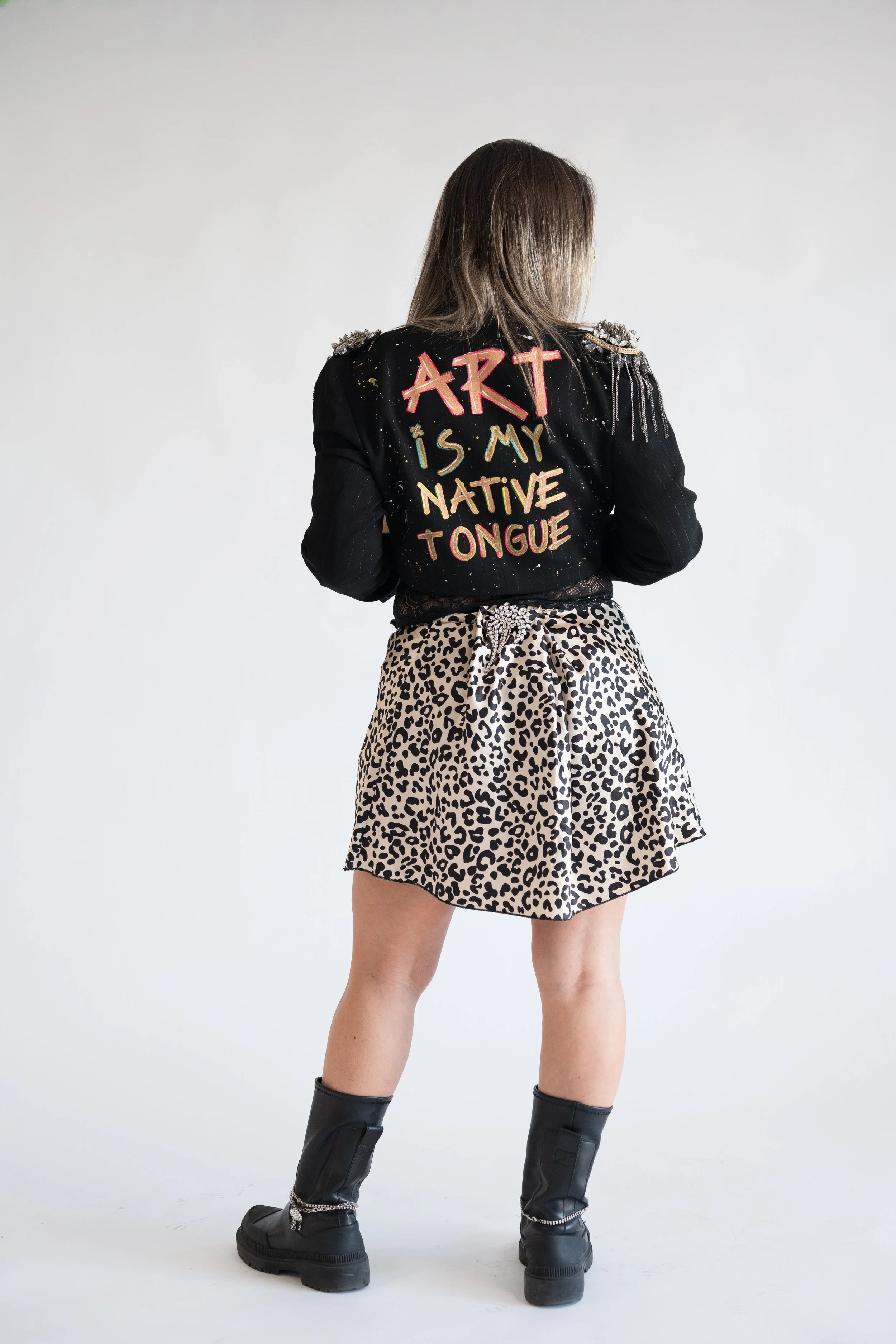 Las Vegas-based visual artist Pao Saenz in studio with large-scale paintings and vibrant artwork