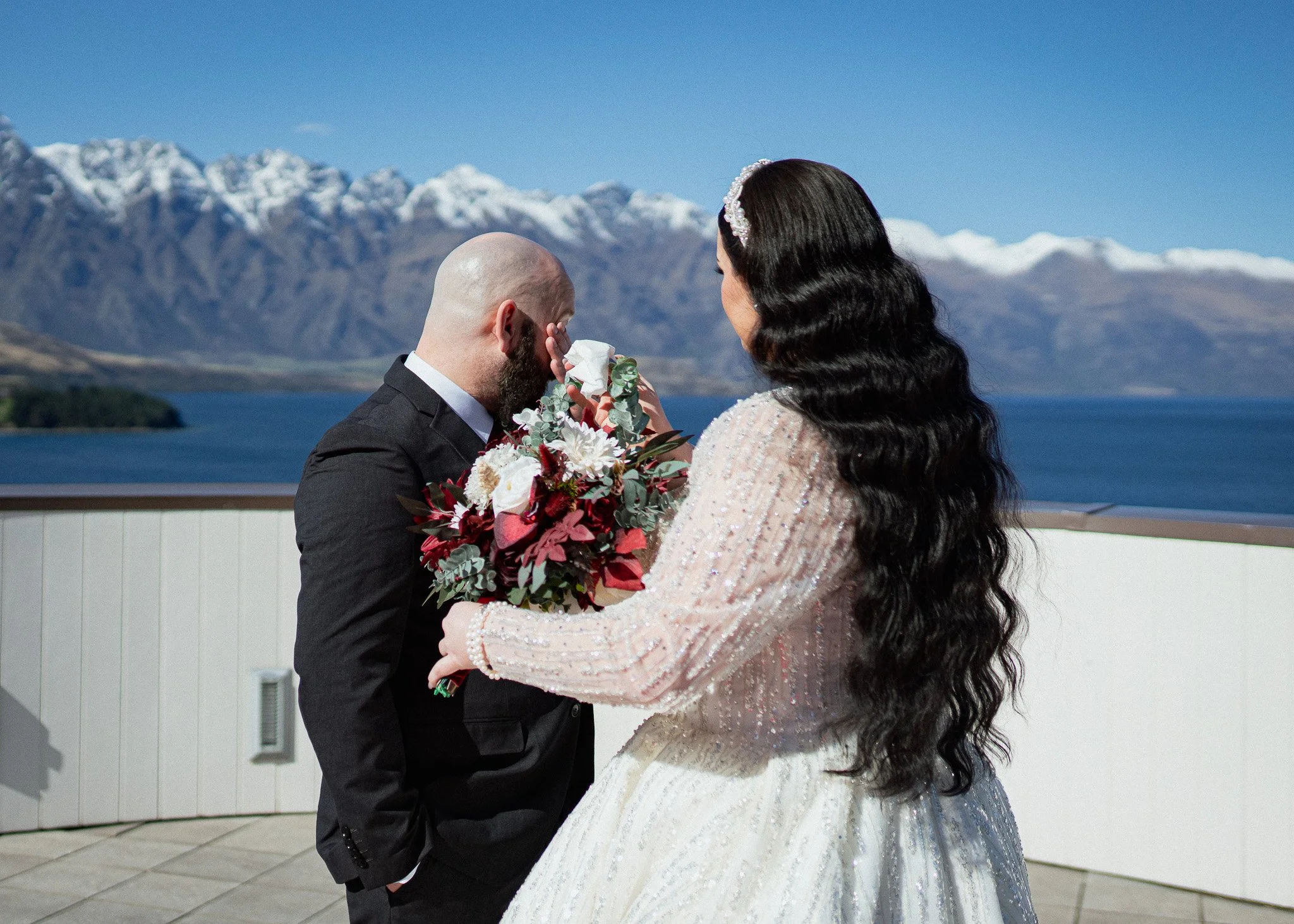    Queenstown winter wedding couple    Snowy wedding portraits Queenstown    Queenstown wedding photographer winter    First look winter wedding Queenstown    Queenstown lakefront bridal party photos    Intimate wedding ceremony Queenstown    Winter 