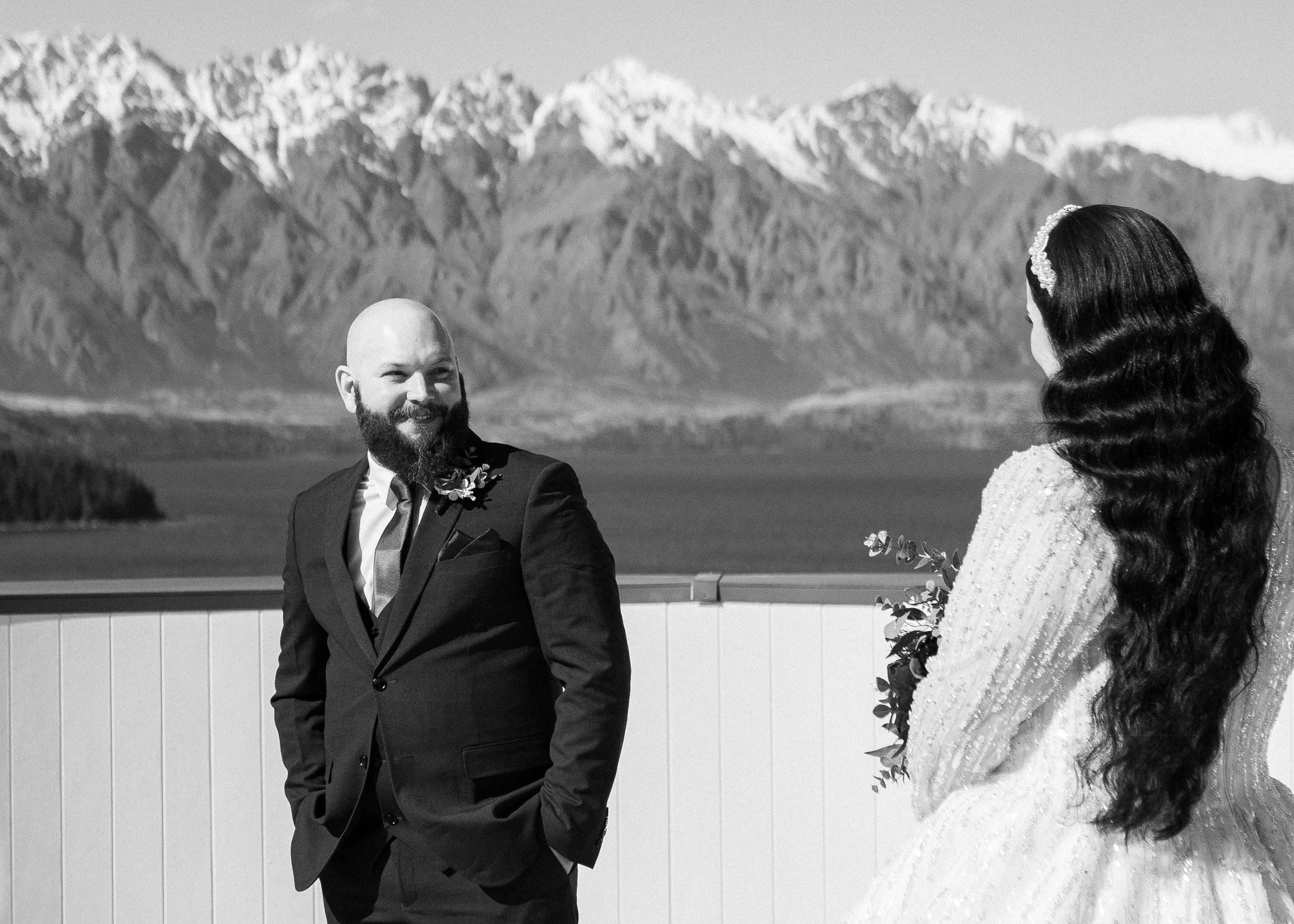    Queenstown winter wedding couple    Snowy wedding portraits Queenstown    Queenstown wedding photographer winter    First look winter wedding Queenstown    Queenstown lakefront bridal party photos    Intimate wedding ceremony Queenstown    Winter 