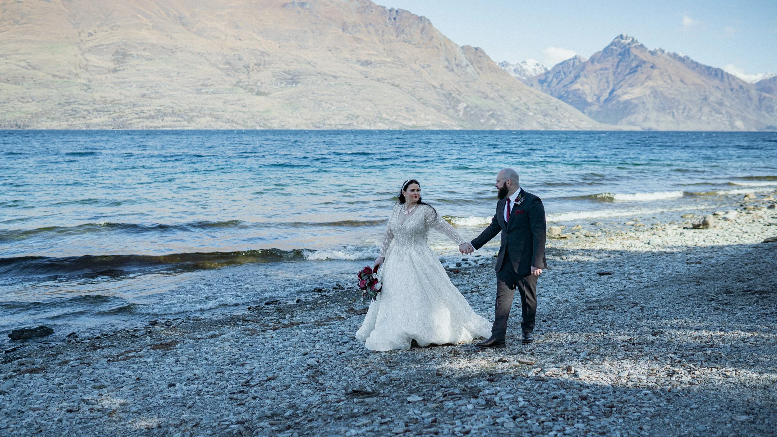    Queenstown winter wedding couple    Snowy wedding portraits Queenstown    Queenstown wedding photographer winter    First look winter wedding Queenstown    Queenstown lakefront bridal party photos    Intimate wedding ceremony Queenstown    Winter 
