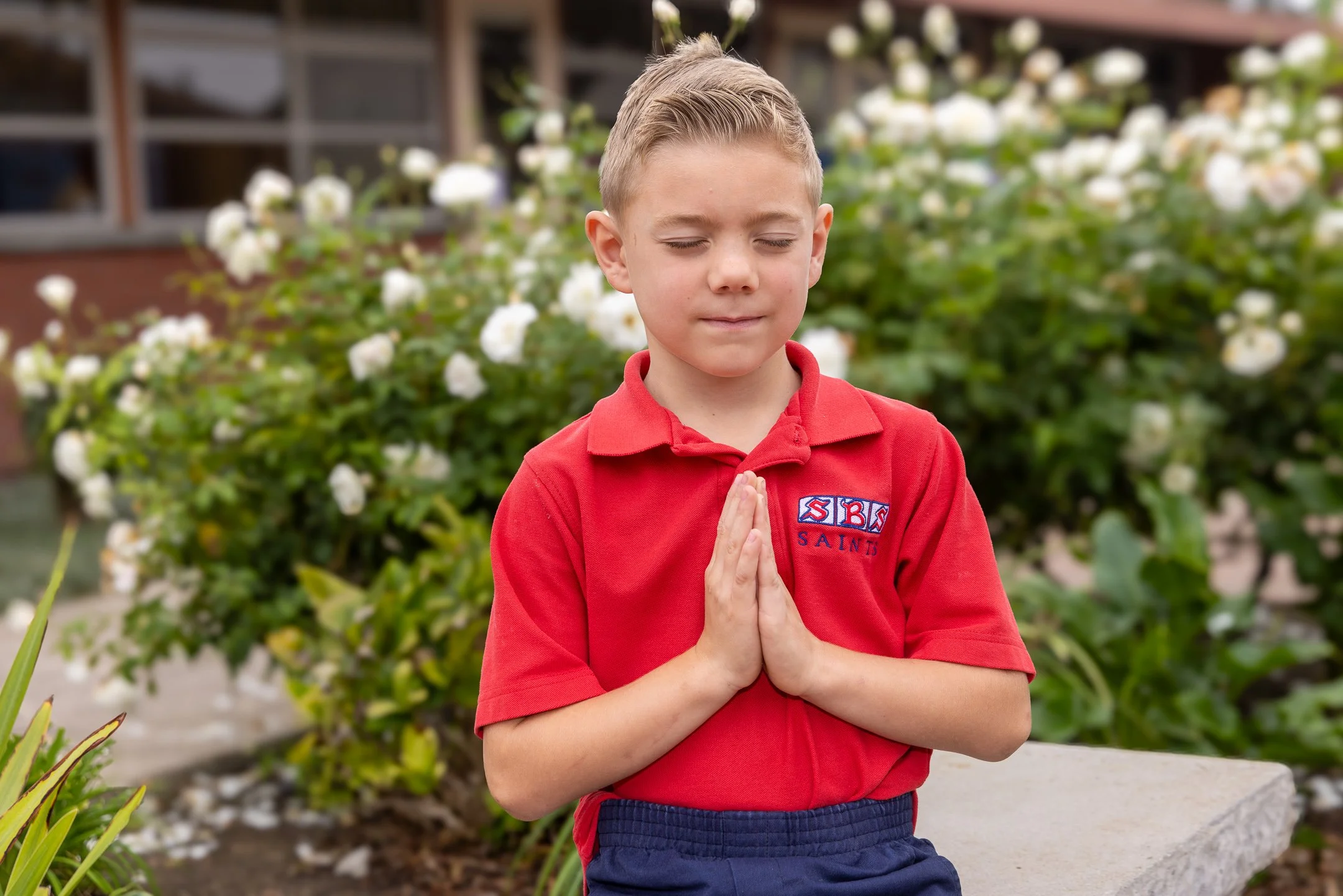 Student praying in the SBS courtyard.