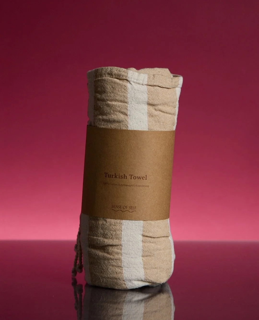 A belly band for @sos.senseofself Turkish Towel, a simple kraft card wrap, assembled with ease that holds the neatly rolled towel. ⁠
⁠
#custompackaging #packaging #customprint #turkishtowel #bathhouse #melbourne #sensofself #wellness