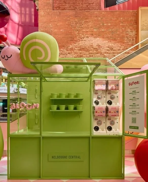 @melbournecentral has teamed up with artist @melissalikessushi to bring BLOOM to life. Her giant, colourful characters have popped up under the Shot Tower, right next to the greenhouse.⁠
⁠
Shoppers can swing by the greenhouse to collect limited-editi