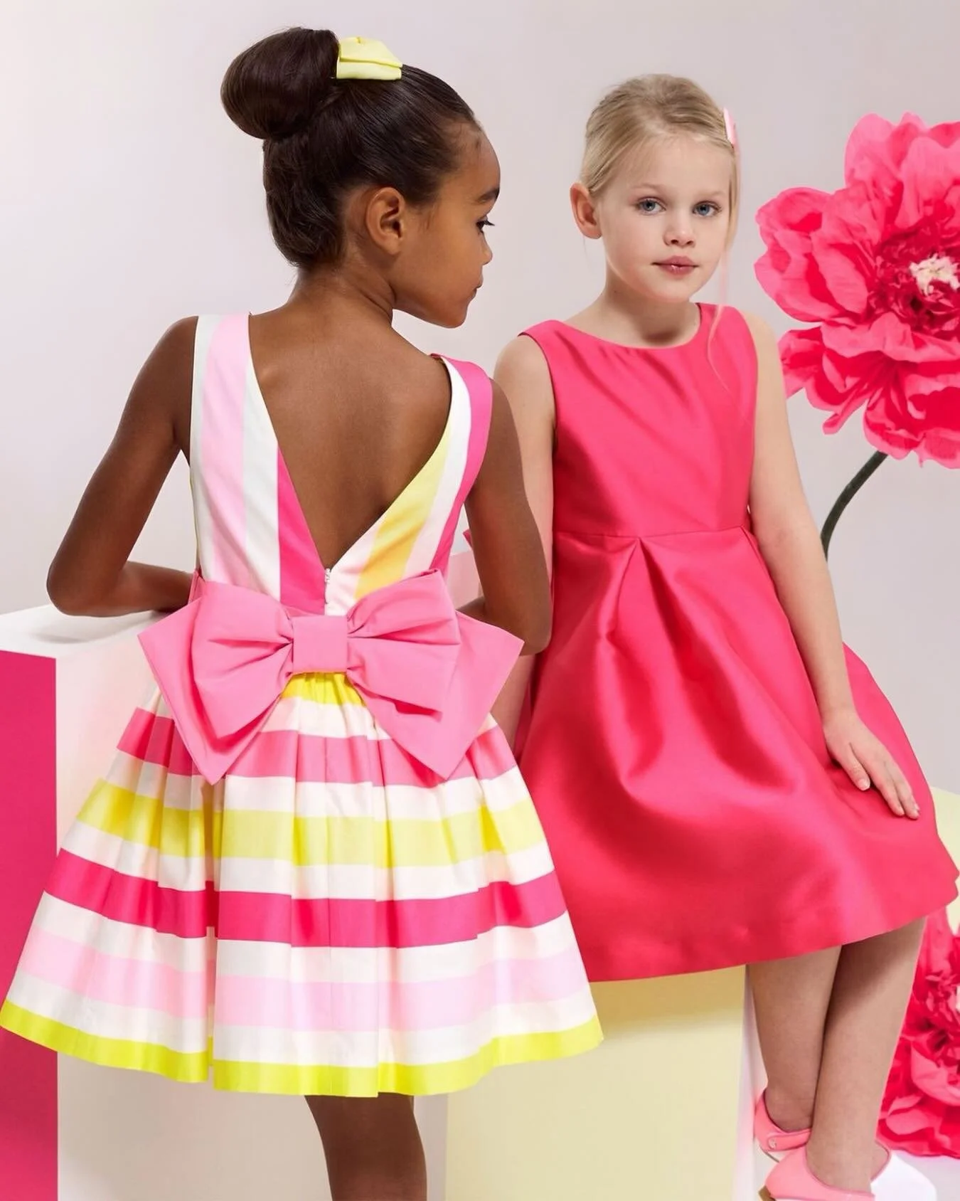 For the birthday girl who sparkles with every twirl. ✨​🎂
Sculpted pleats, statement bows, and luxe fabrics like
Italian Mikado and cotton satin add a touch of magic to her special day.​

Explore our new elegant ceremony dresses in stores and
online.