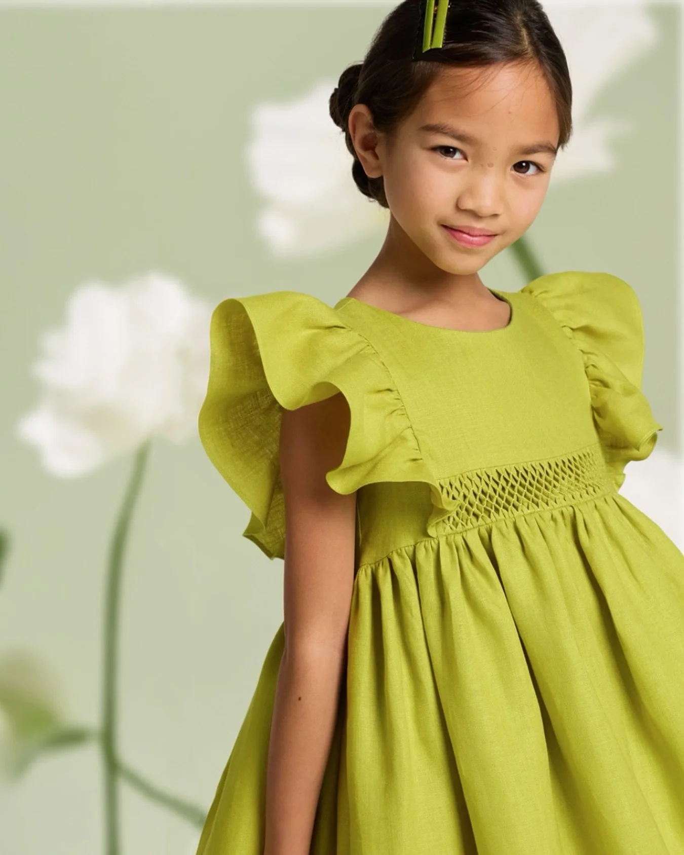 A touch of garden serenity.🌼​

Light linen, delicate smocking and softly ruffled sleeves come together in a silhouette inspired by classic heirloom dressing. In a statement moss hue, it captures the poetry of summer celebrations.​

Explore in stores