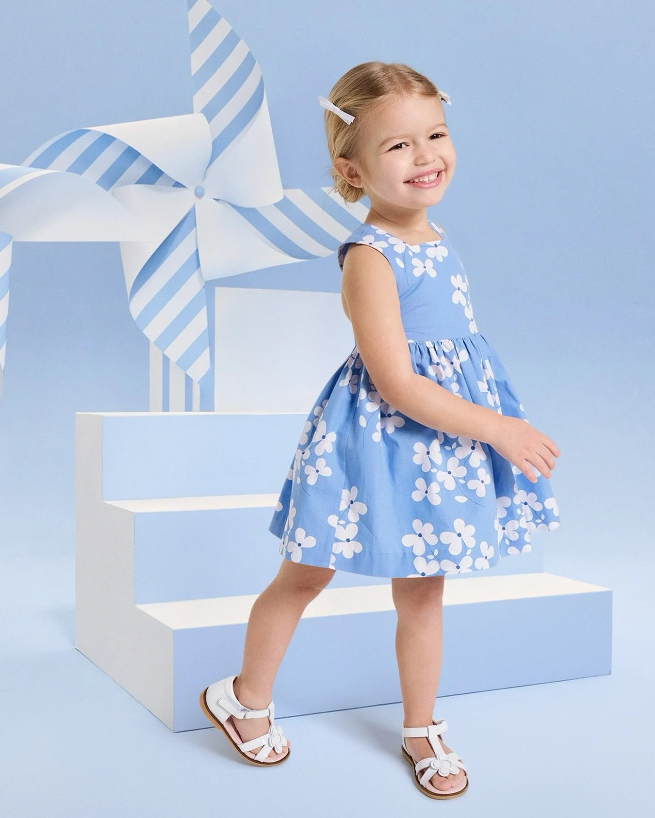 Light, floral, and perfect for every little twirl.​
​
With its crossover back, delicate square neckline and soft floral pattern, this charming dress is made for sunny celebrations.​
​
Available in store and online.​