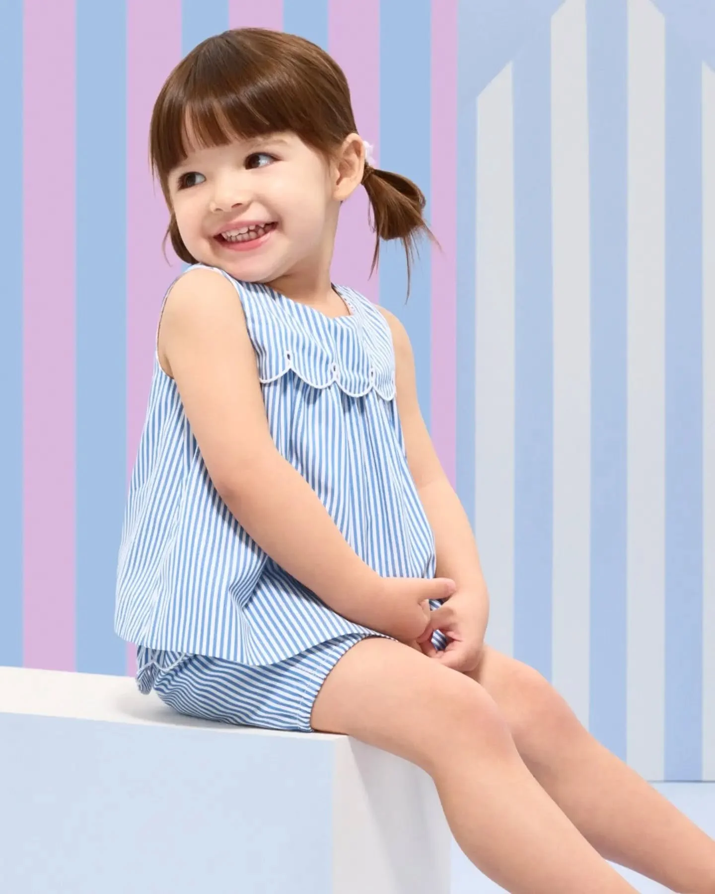 Timeless blue-and-white stripes, airy volume and delicate scalloped finishing embody Jacadi chic beautifully.

With a lightweight crossover top and soft balloon shorts, this refined set is made for sun-filled days.

Available in store and online.