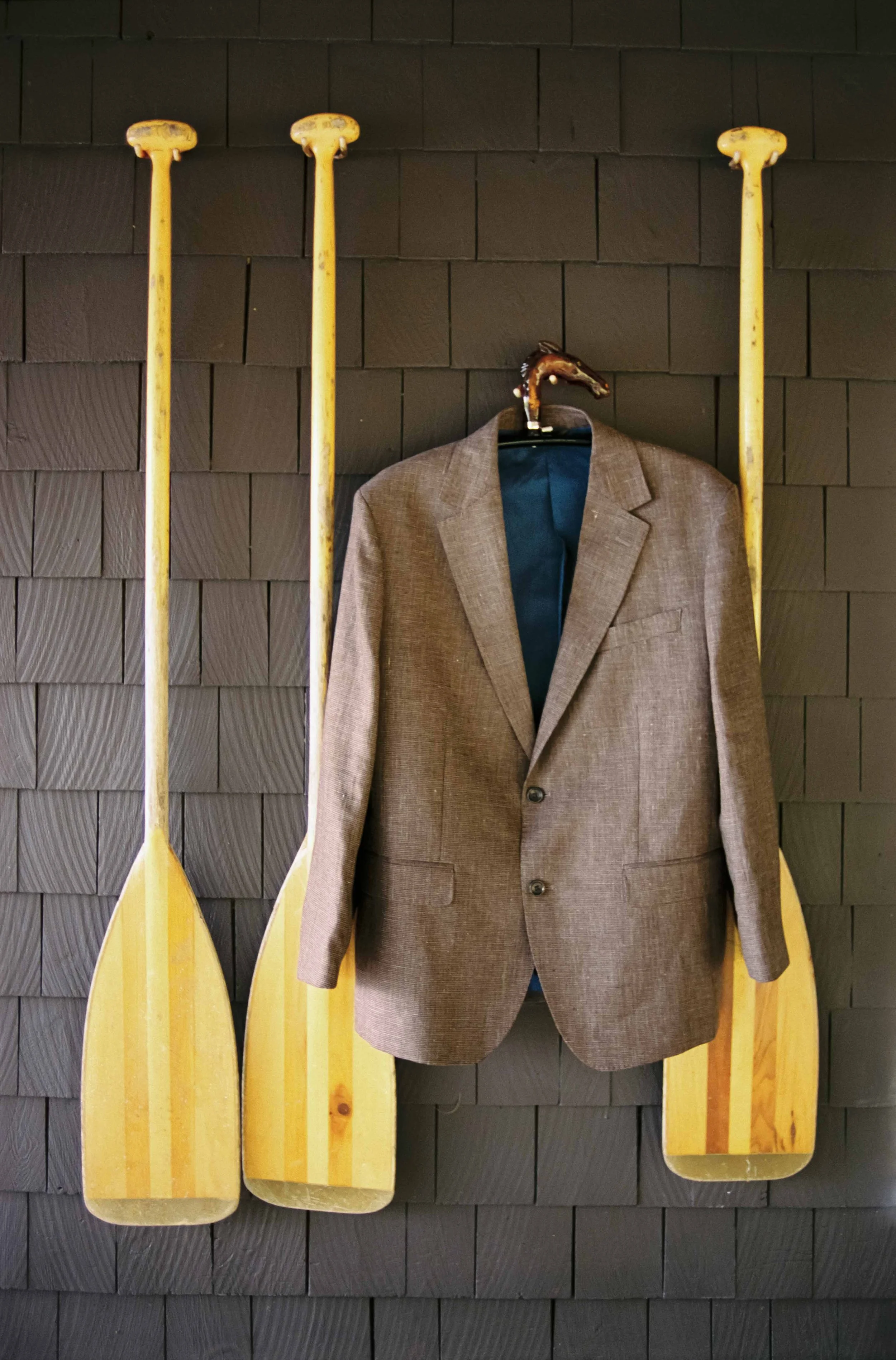 Grooms wedding jacket hanging on a wall in Maine