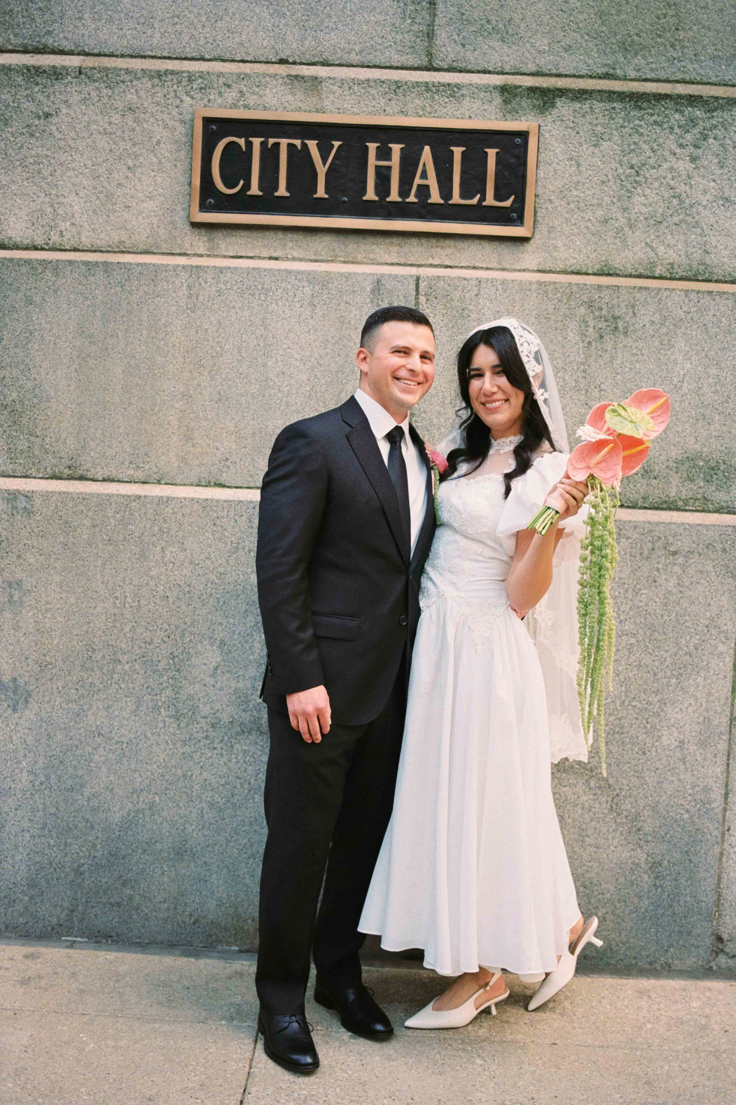 Couples portrait by Chicago City Hall sign