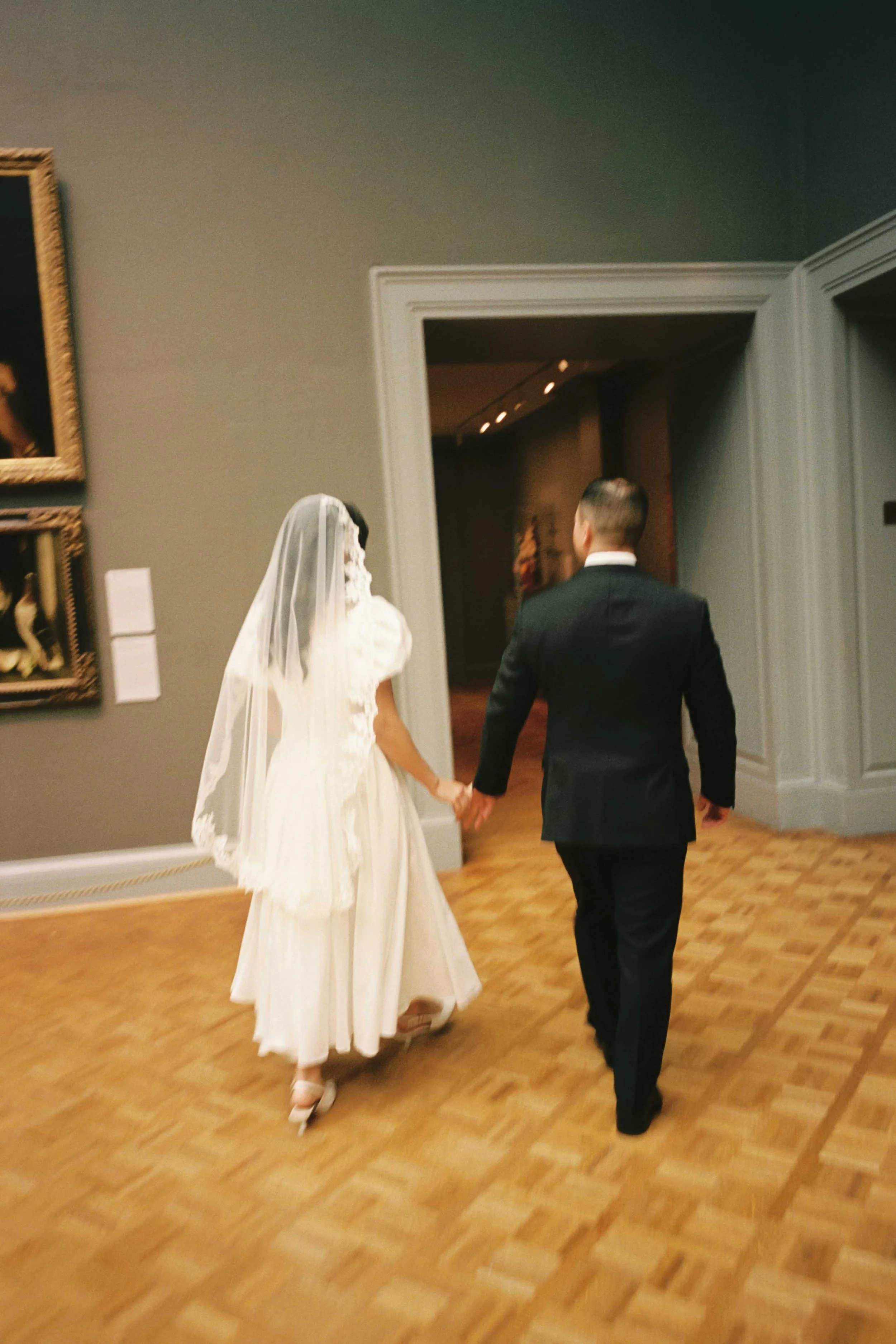 Wedding couple walking through an art museum