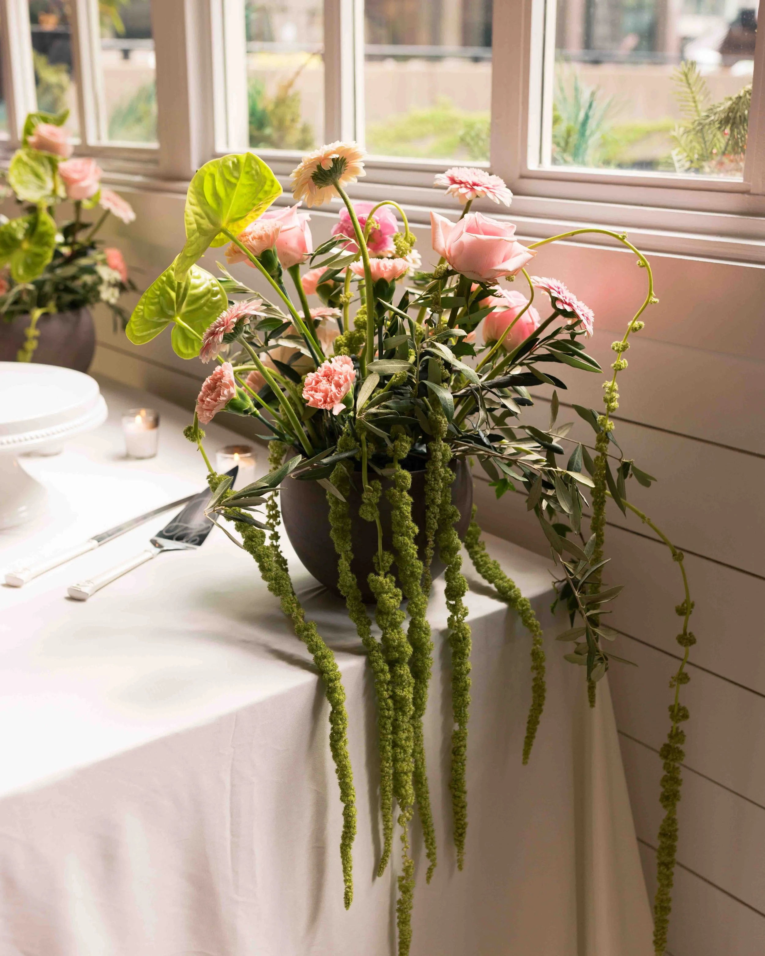 Green and pink wedding floral arrangement at Nonnina's