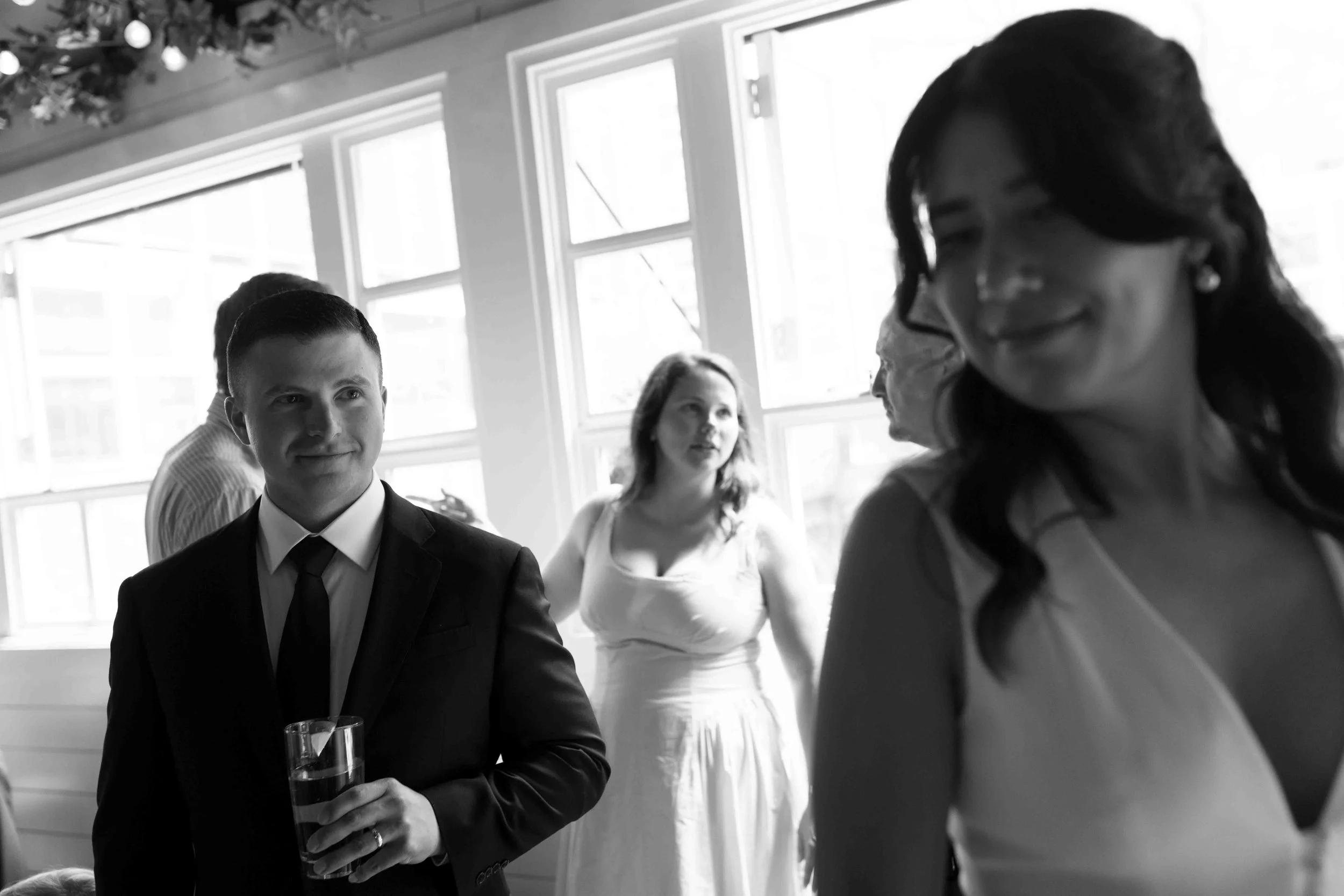 Candid moment of the groom glancing at the bride
