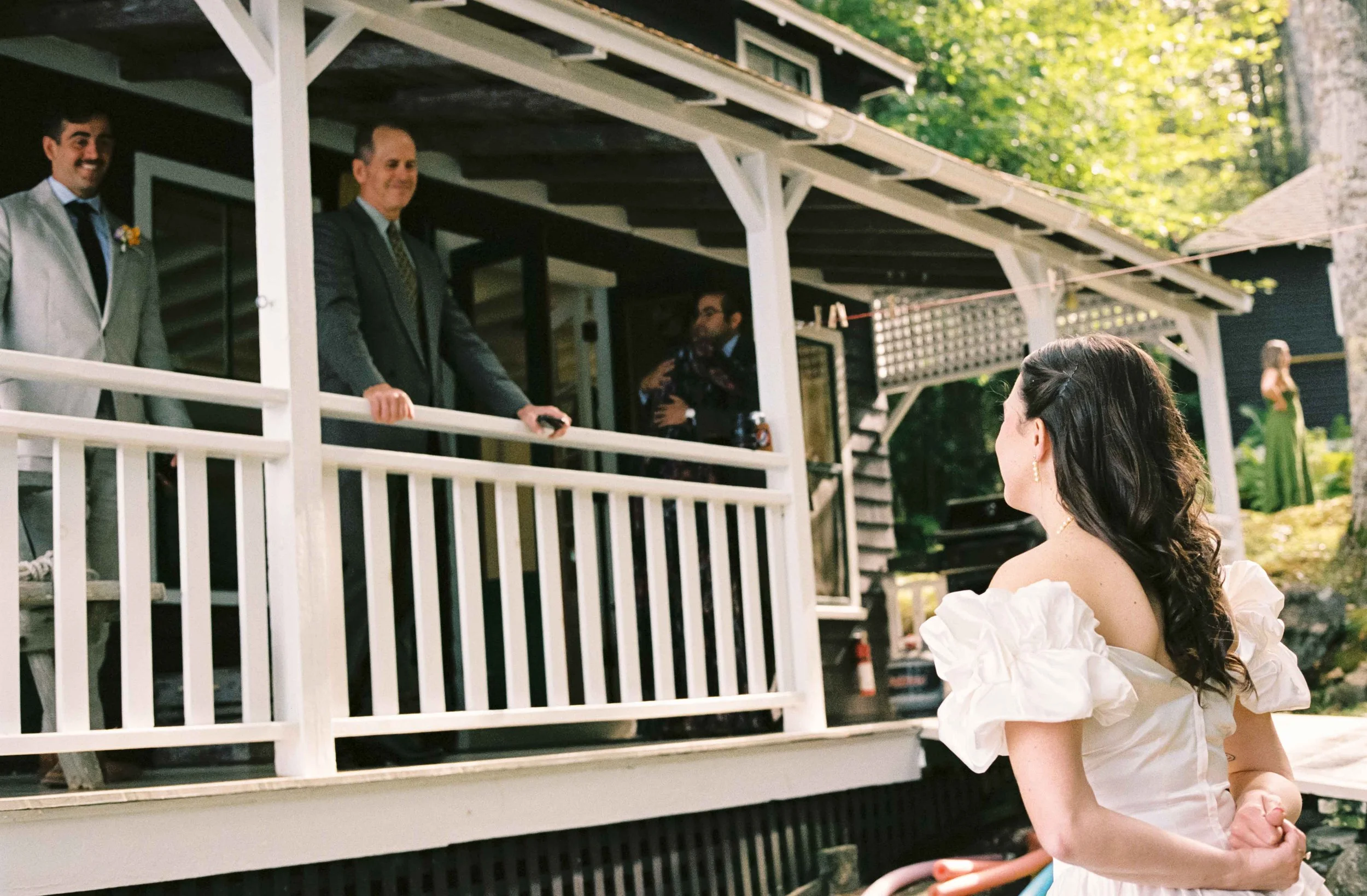 Bride talking to her brother and dad on her wedding day in Maine