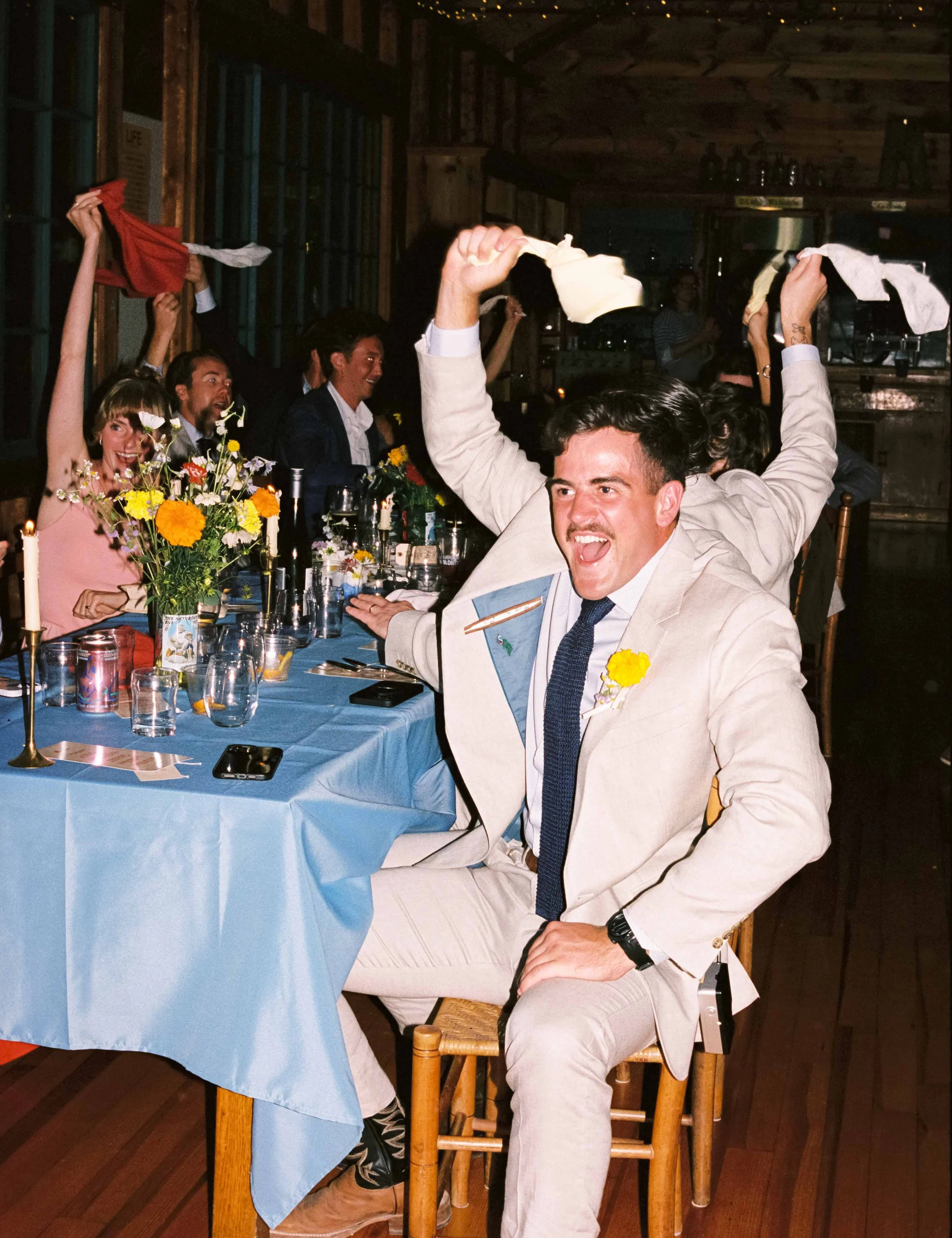 Wedding guests waving their napkins in their hand in the air