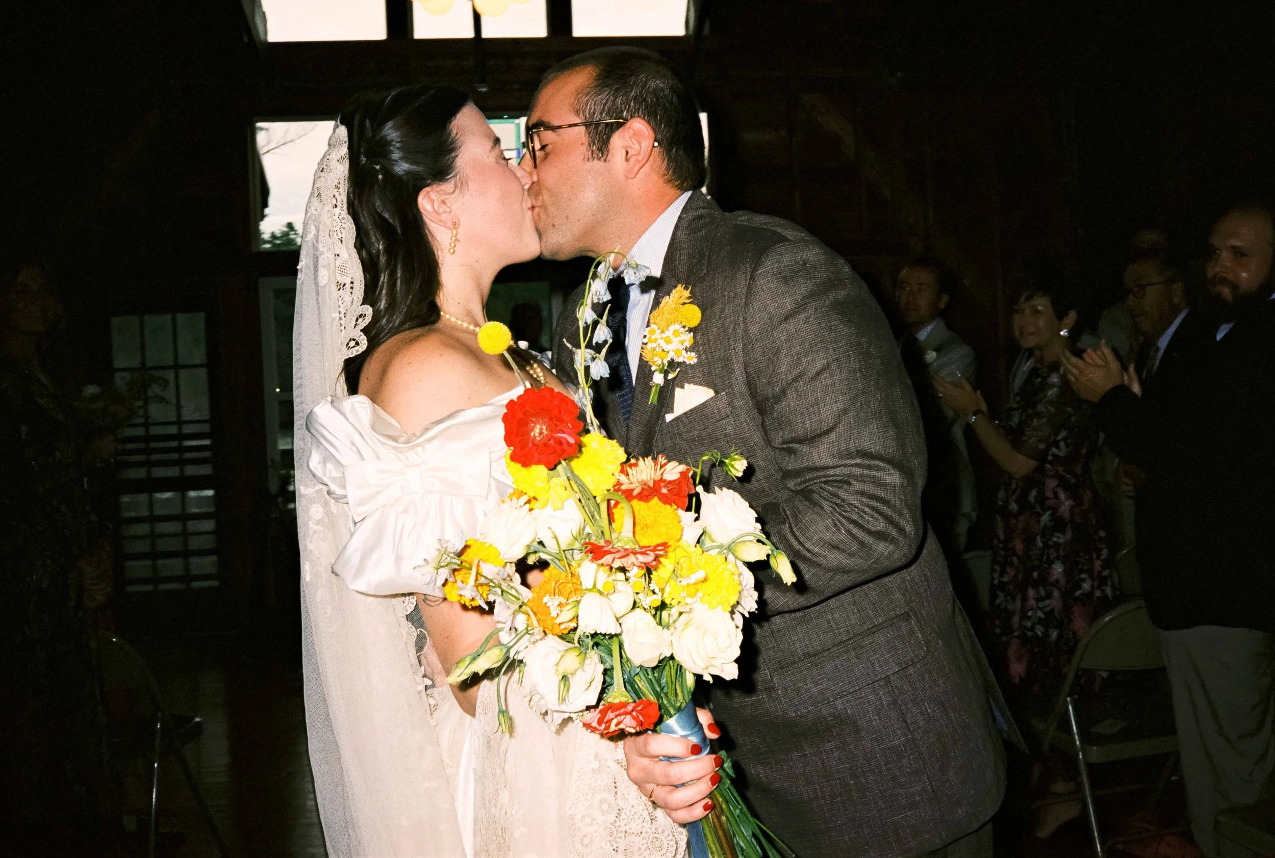 Wedding couple kissing down the aisle