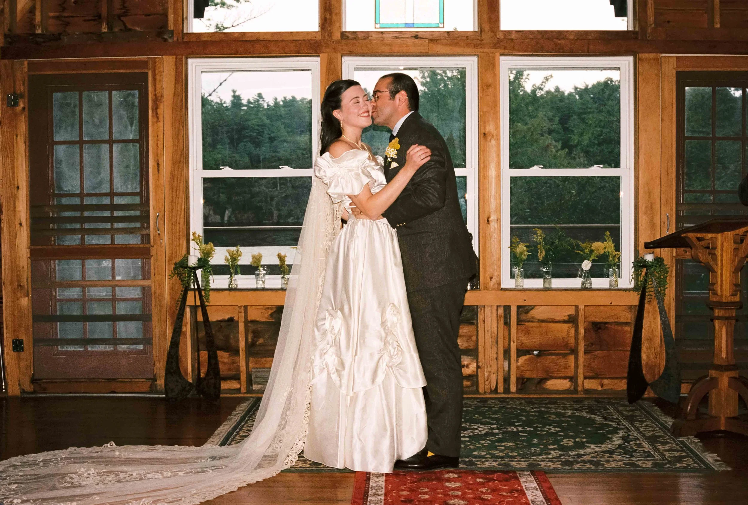 Groom kissing his bride at the alter on their wedding day