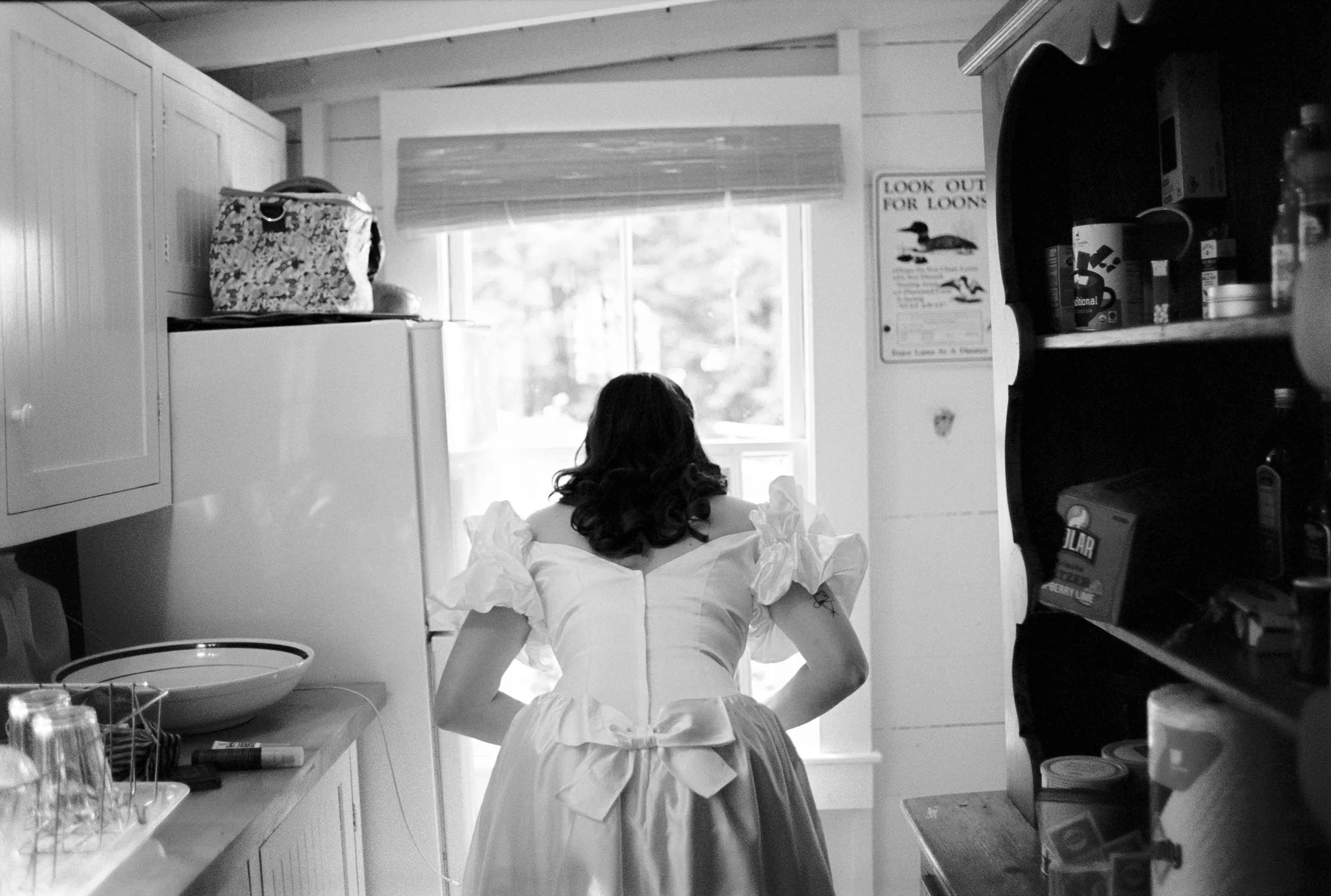 Bride looking out the window for her groom