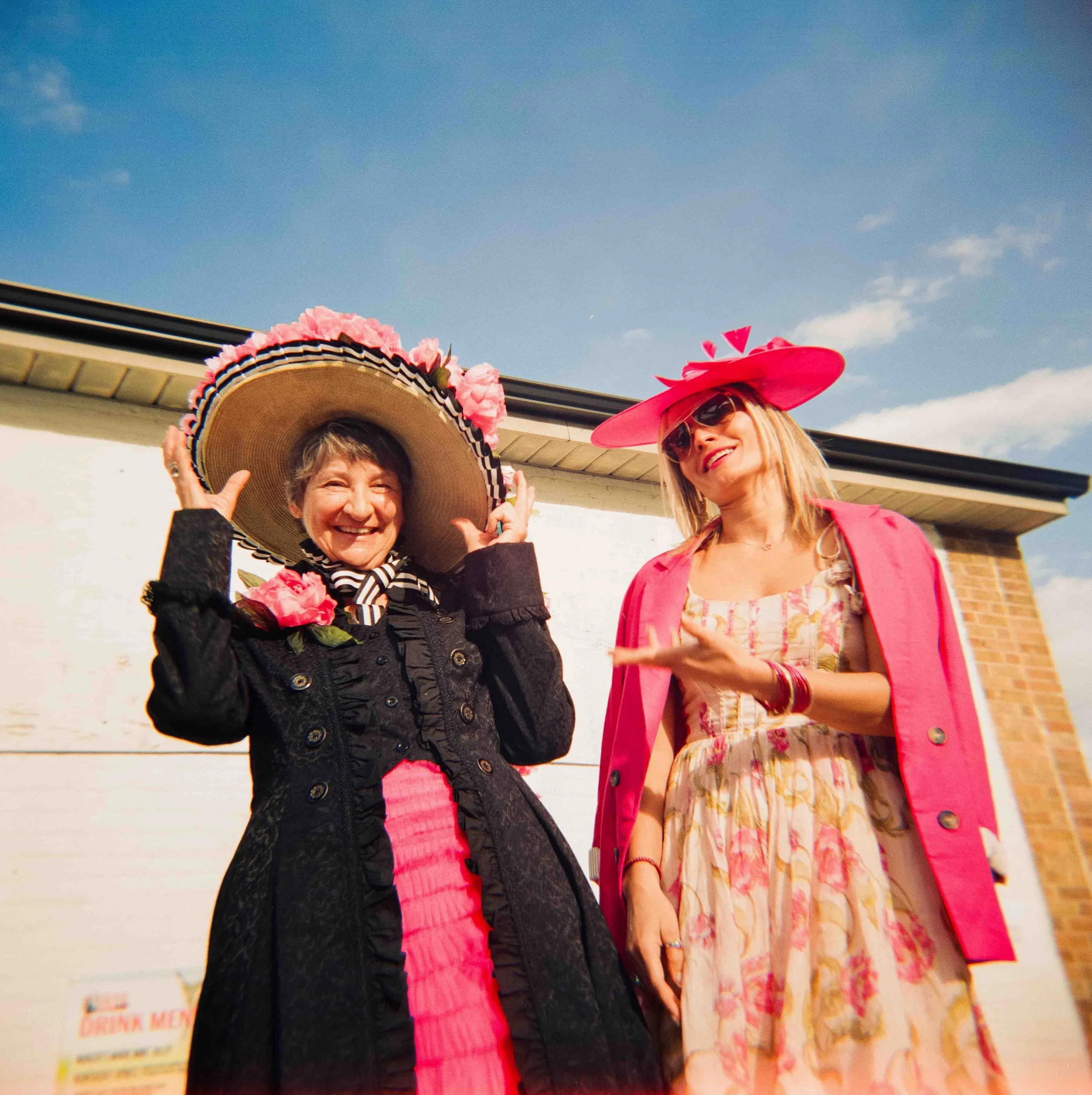 Women at the Kentucky Derby Day winning a contest and laughing