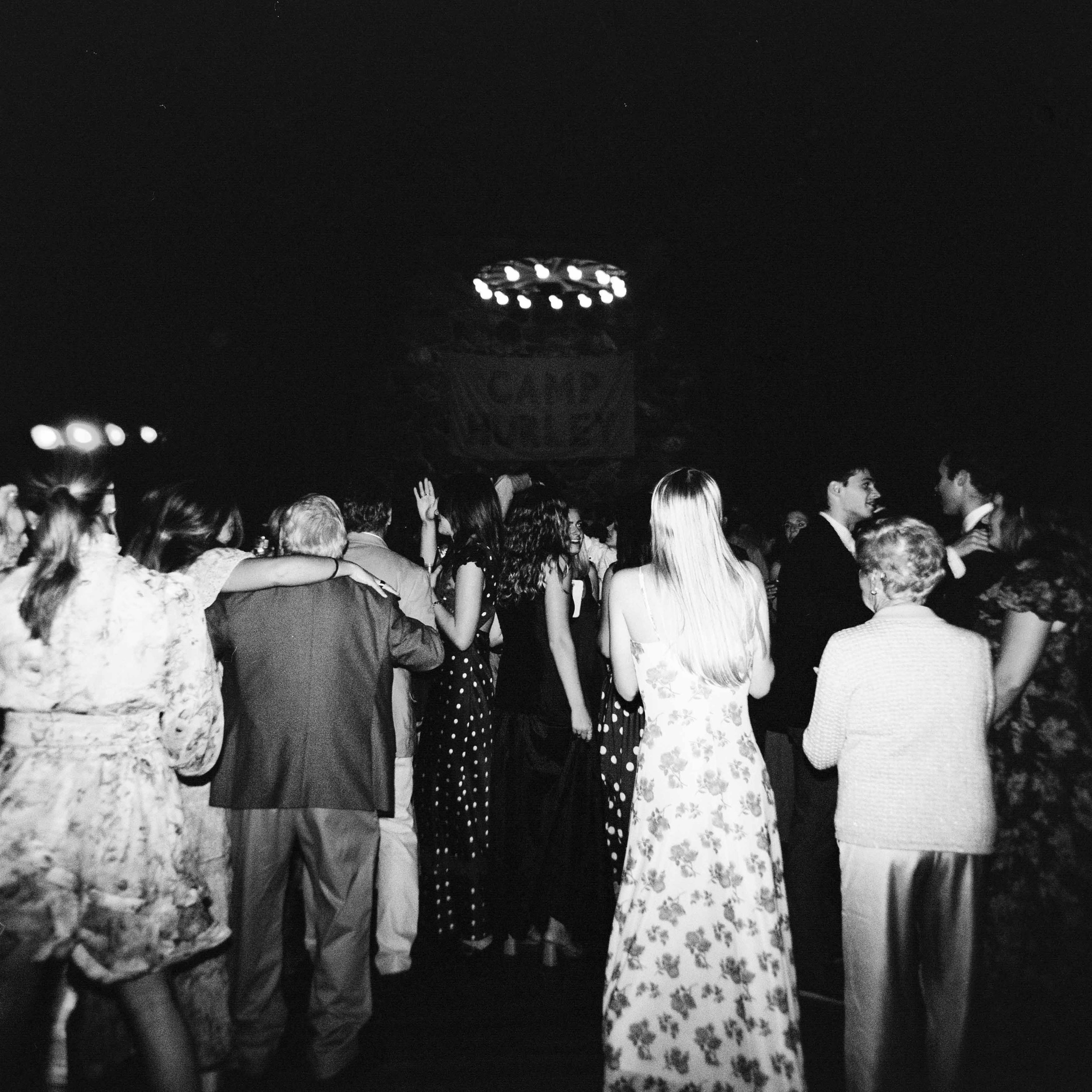 Black and white photo of the dance floor at a wedding on film