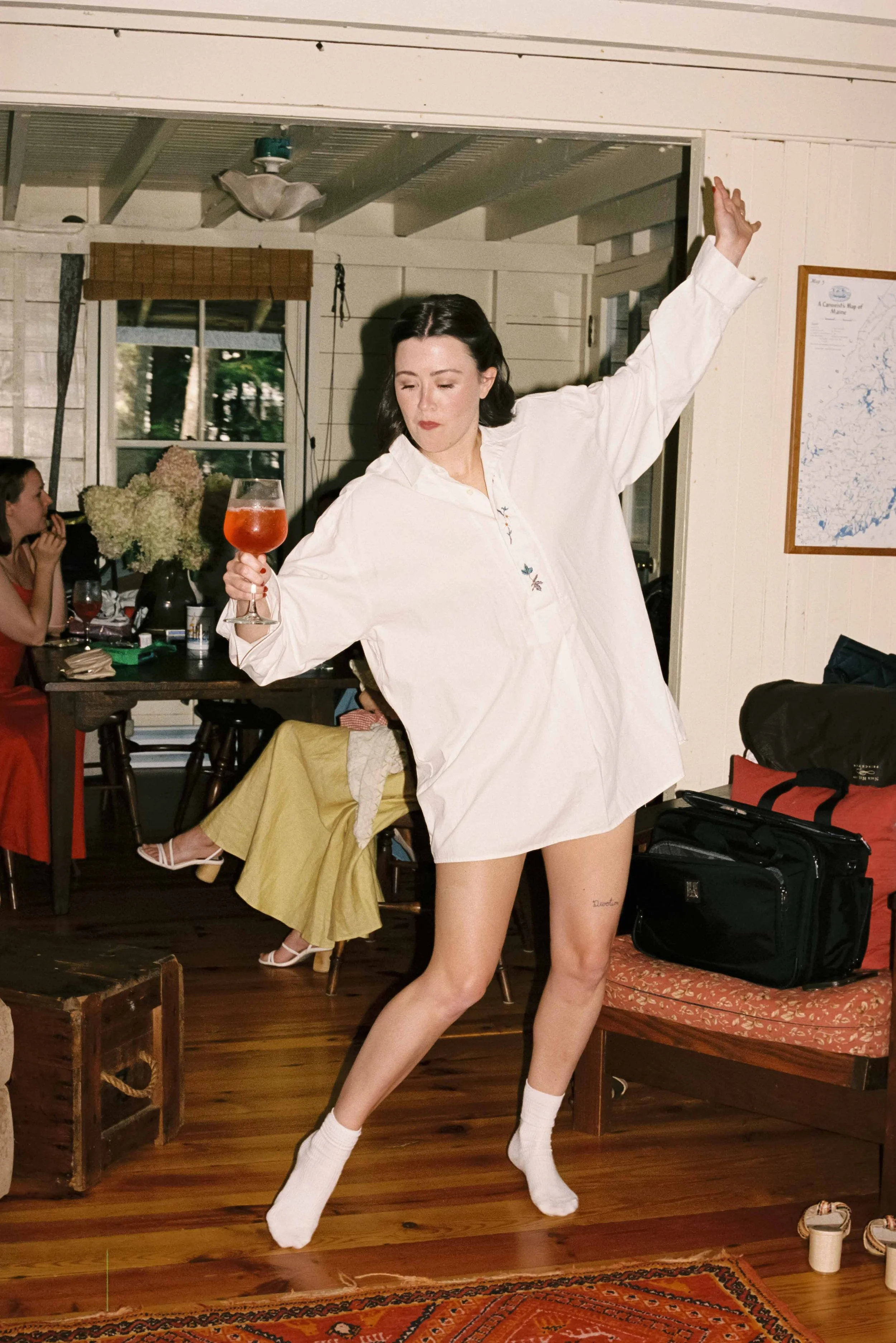 Bride sliding across the floor in her Maine cabin