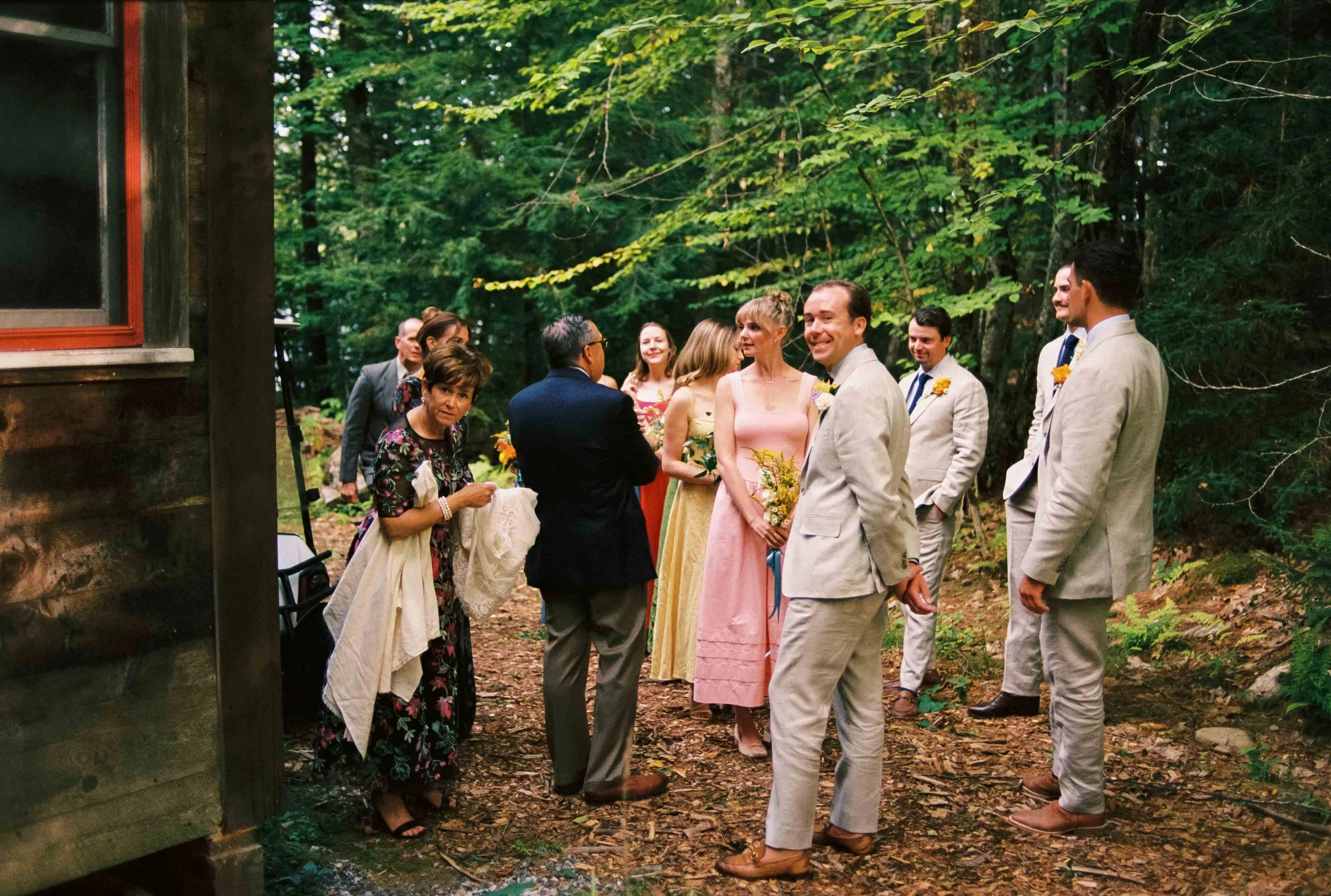 Candid of the grooms family looking at the camera before their ceremony