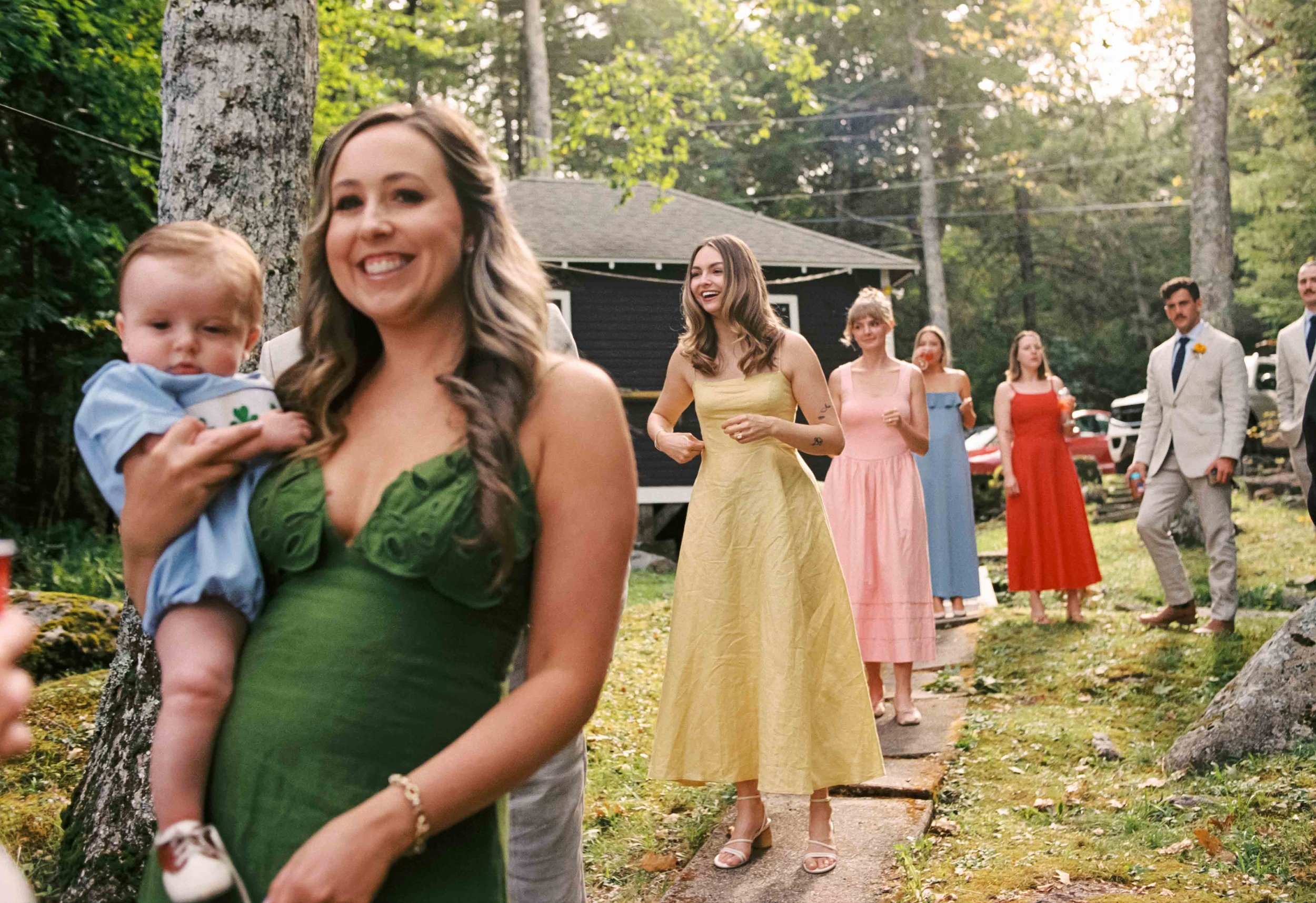 Candid of wedding party in bright colored dresses