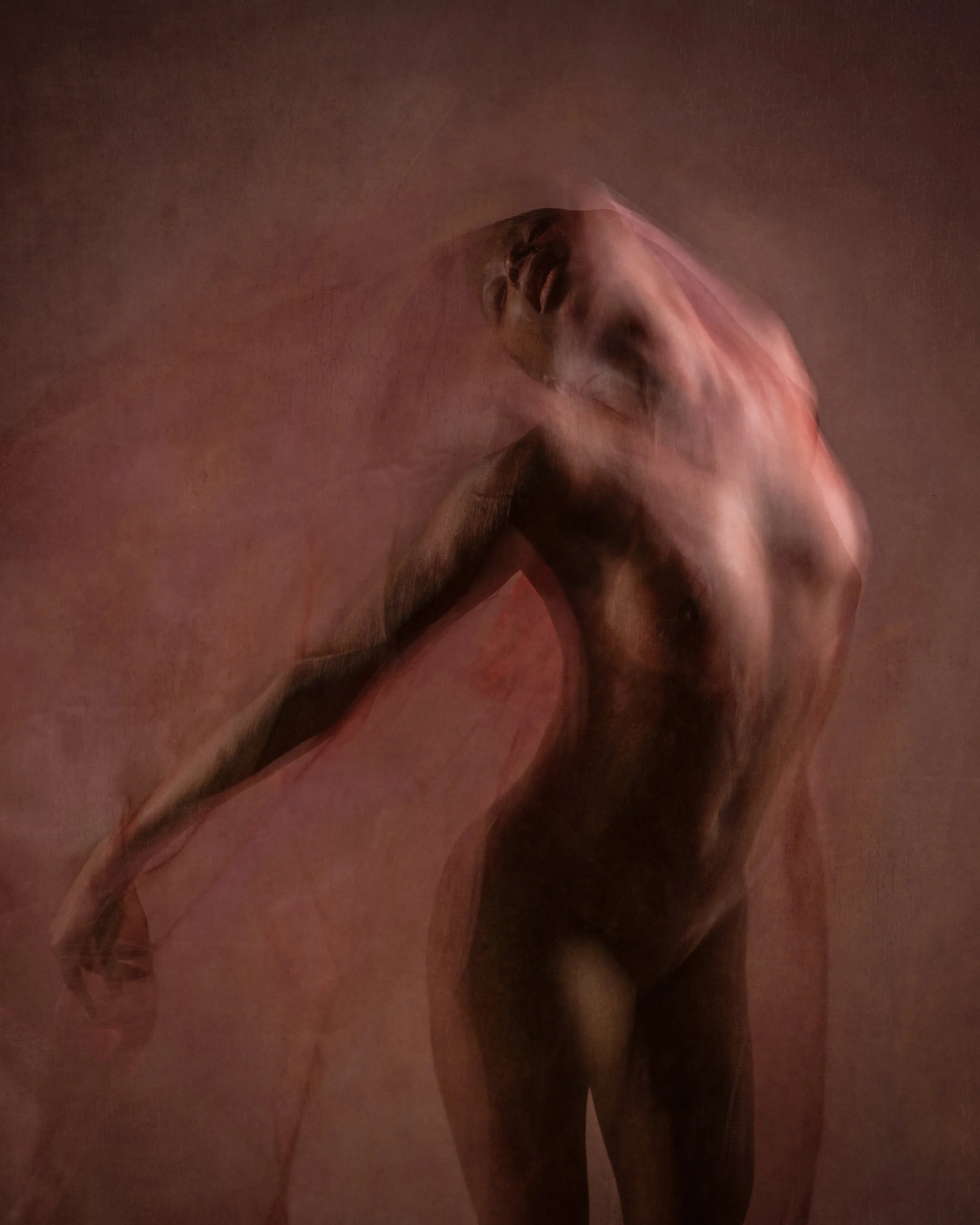 Photograph of a dancer moving with fabric to create an ethereal effect.
