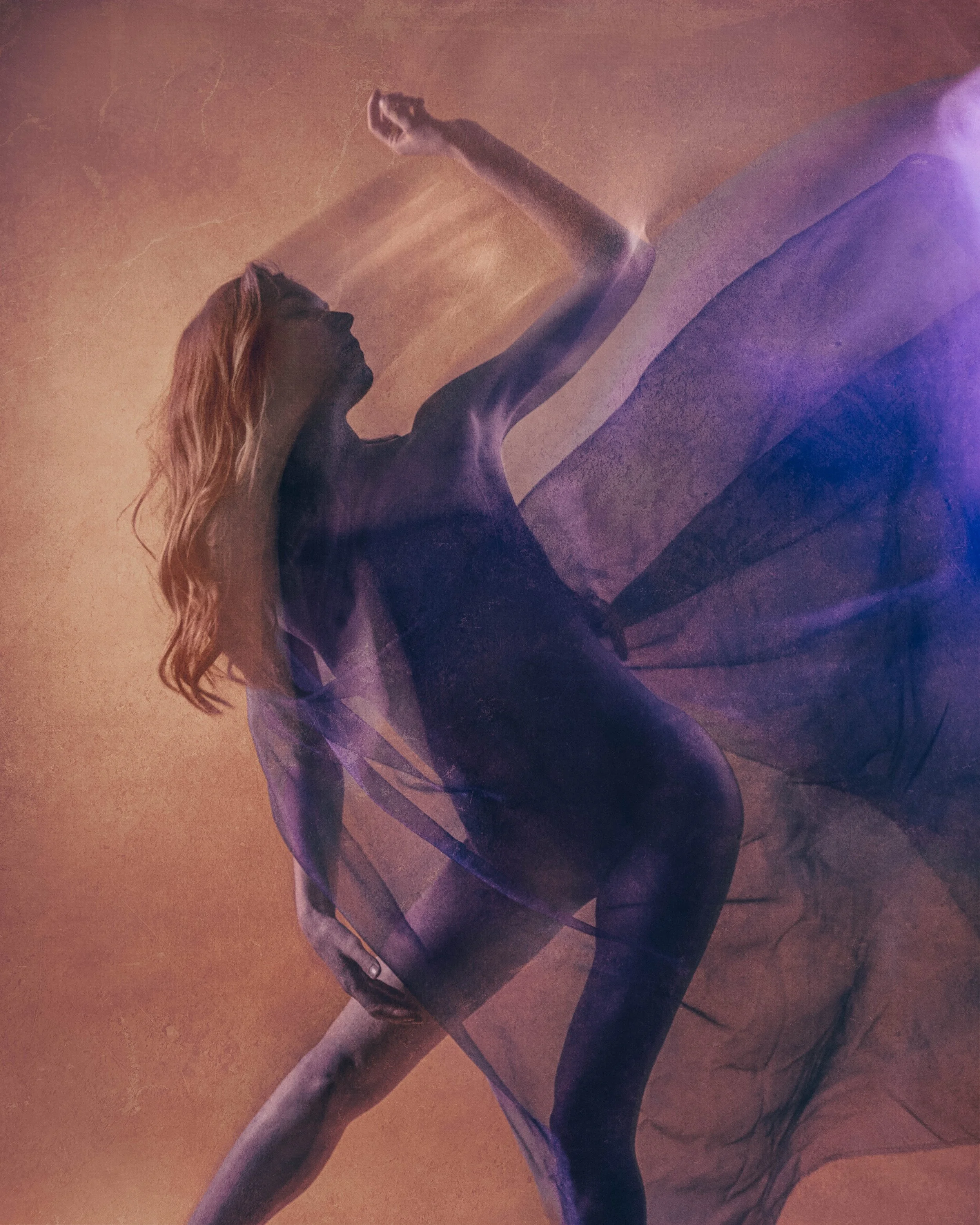 A dancer moving with purple fabric under a long exposure to create a ethereal painterly image