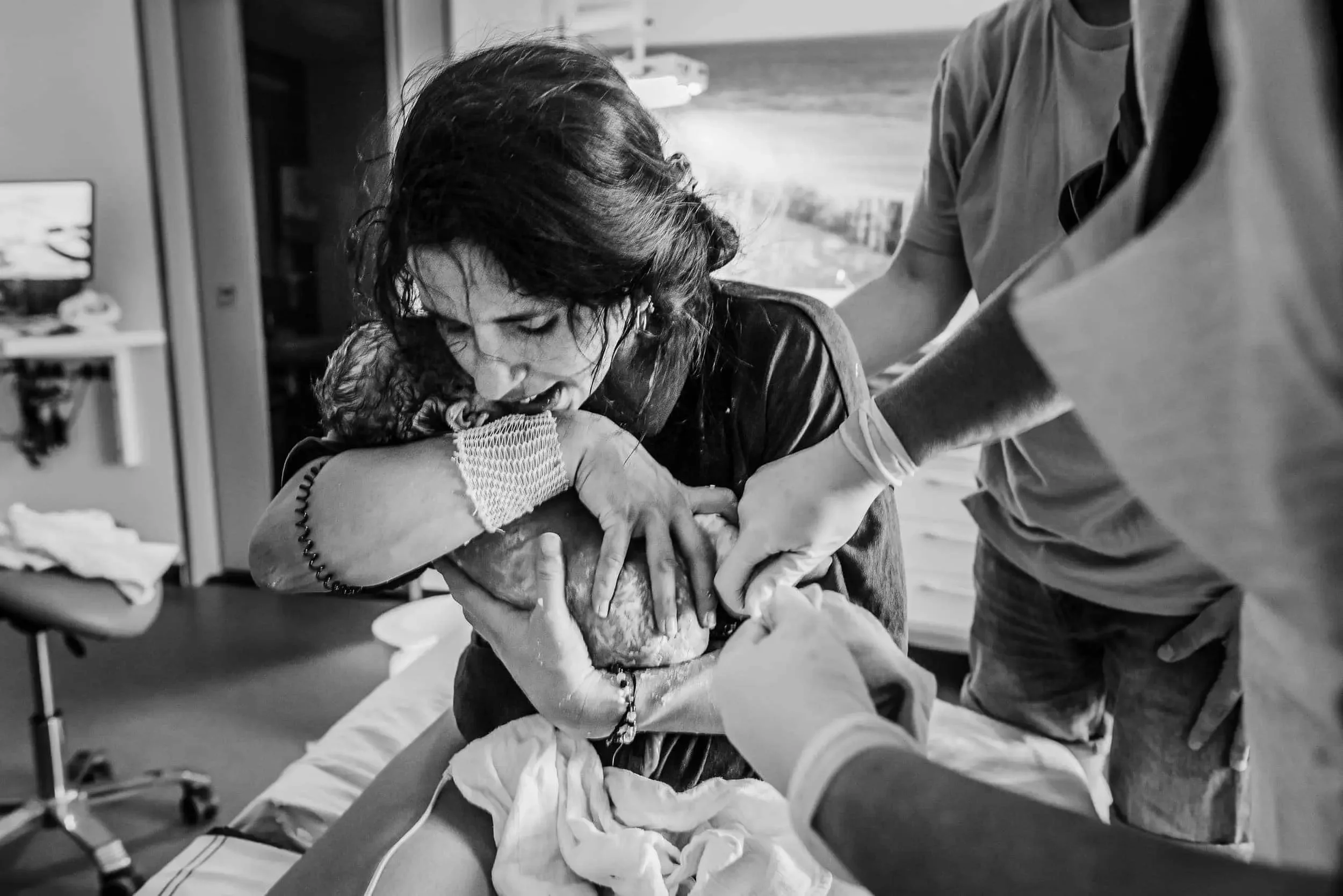 Image captured by Tania Fragoso Birth Doula women holding her newborn baby at the hospital in Amsterdam