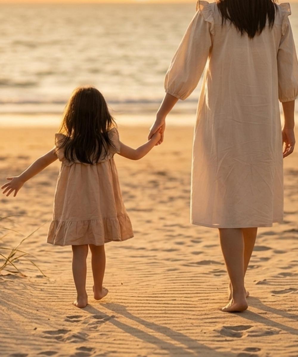 mother and daughter walking through the beach.jpg