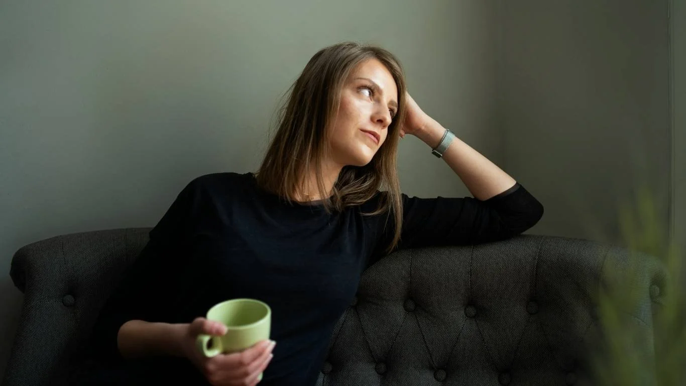 Woman sitting quietly — understanding AuDHD as an autistic ADHD mother
