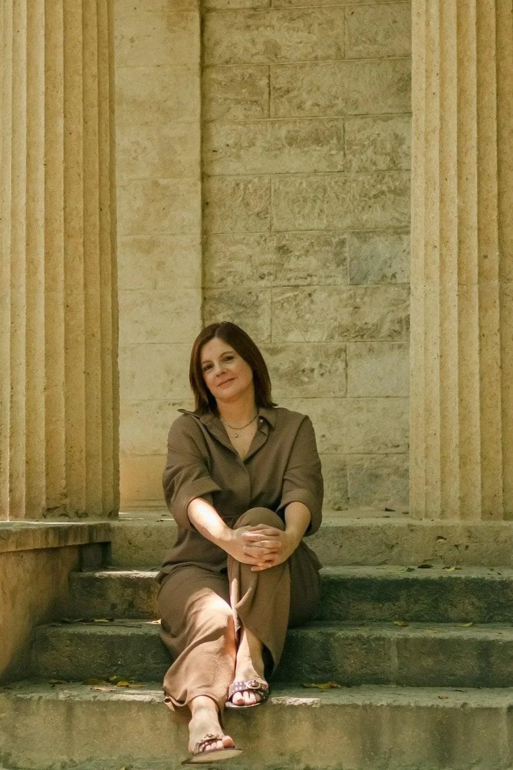 Tania Fragoso sitting on steps in a buildig in Malaga