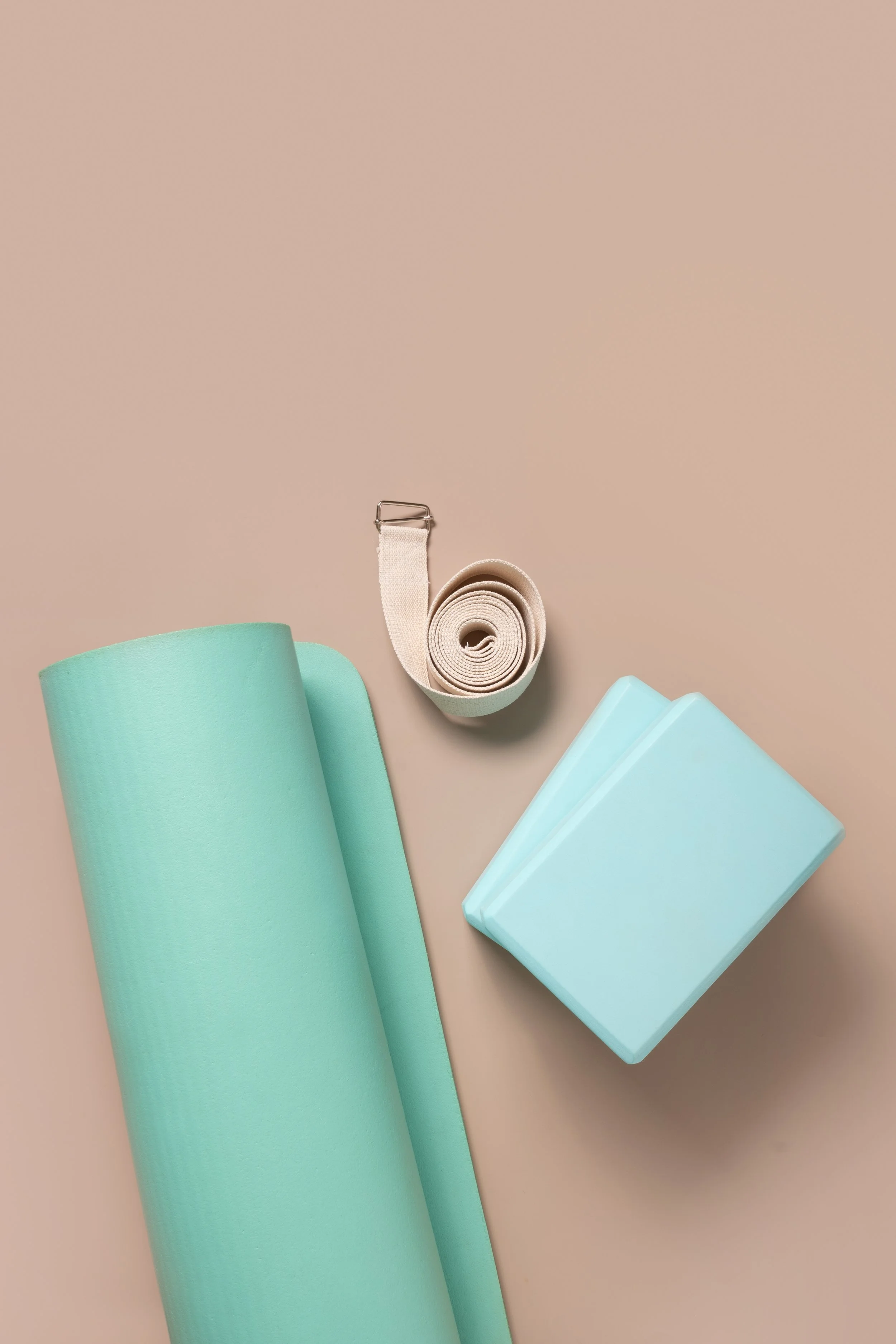 green-yoga-mat-two-blocks-water-clock-white-belt-yoga-relaxation-meditation-concept.jpg