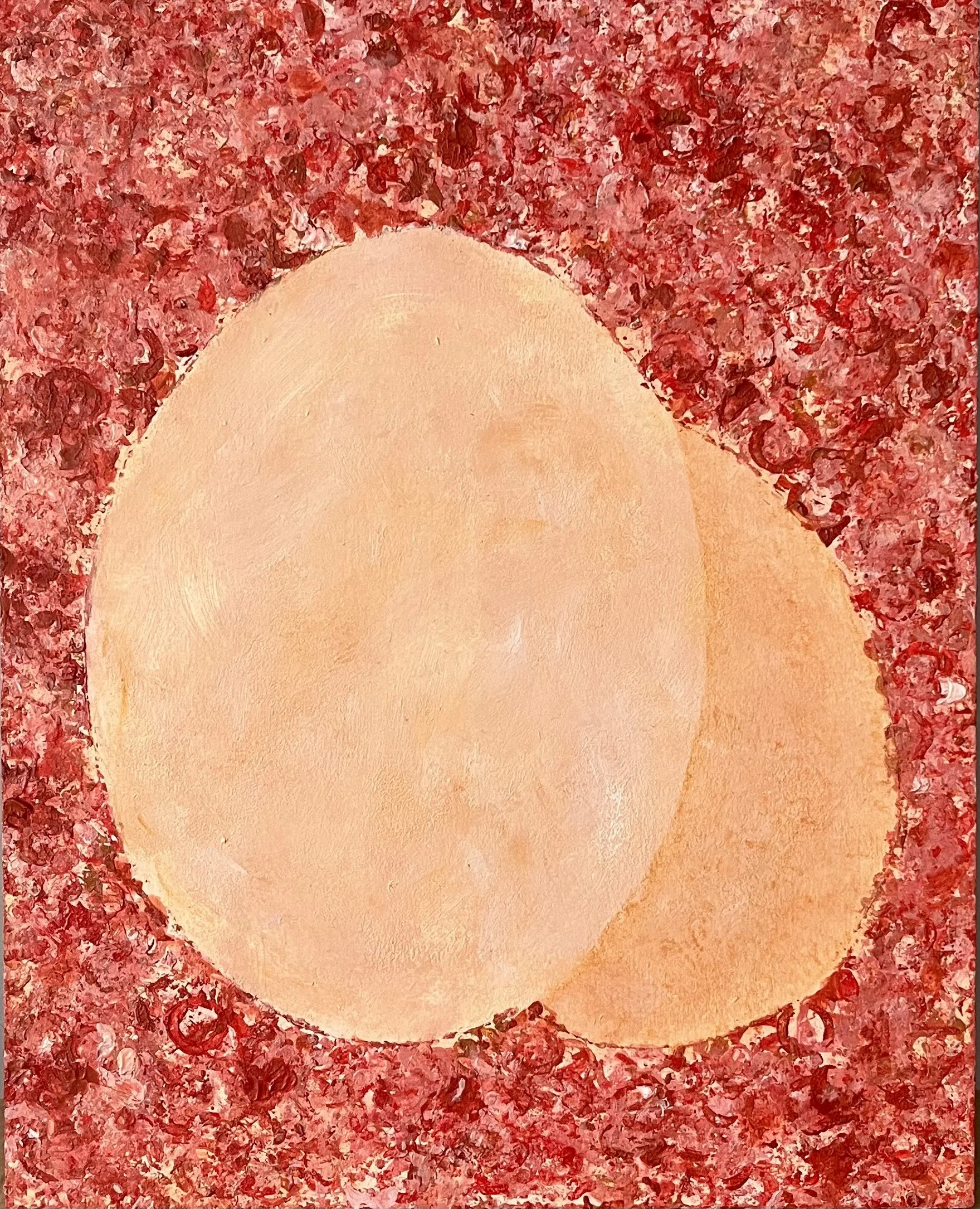 Close-up of a pinkish egg with a red, textured background.