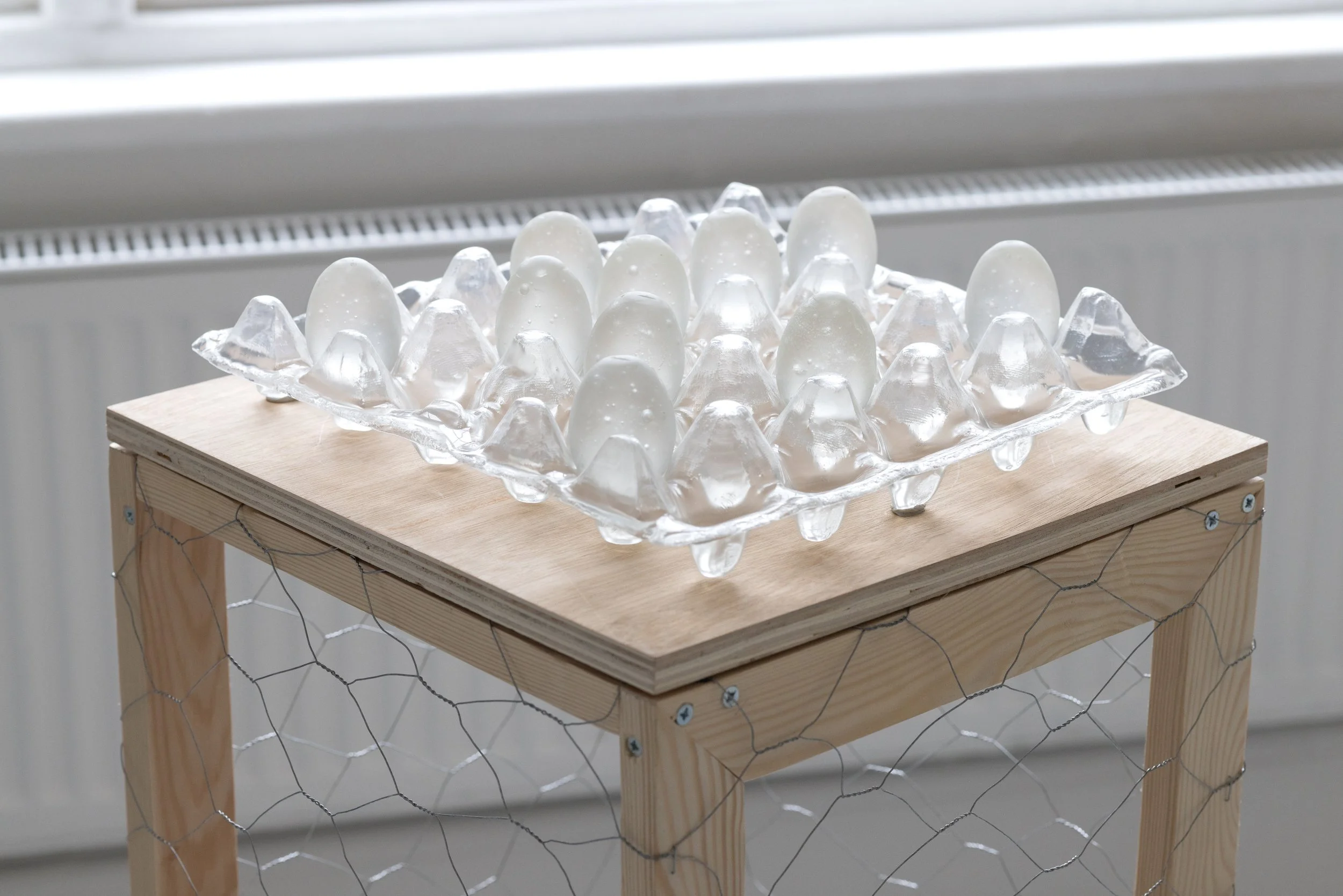 Untitled (Glass Carton with Eggs), 2025–2026
Slumped and cast glass on custom wood and chicken wire cage plinth.
Carton: 8 x 30 x 30 cm. Plinth: 90 x 34 x 34 cm.