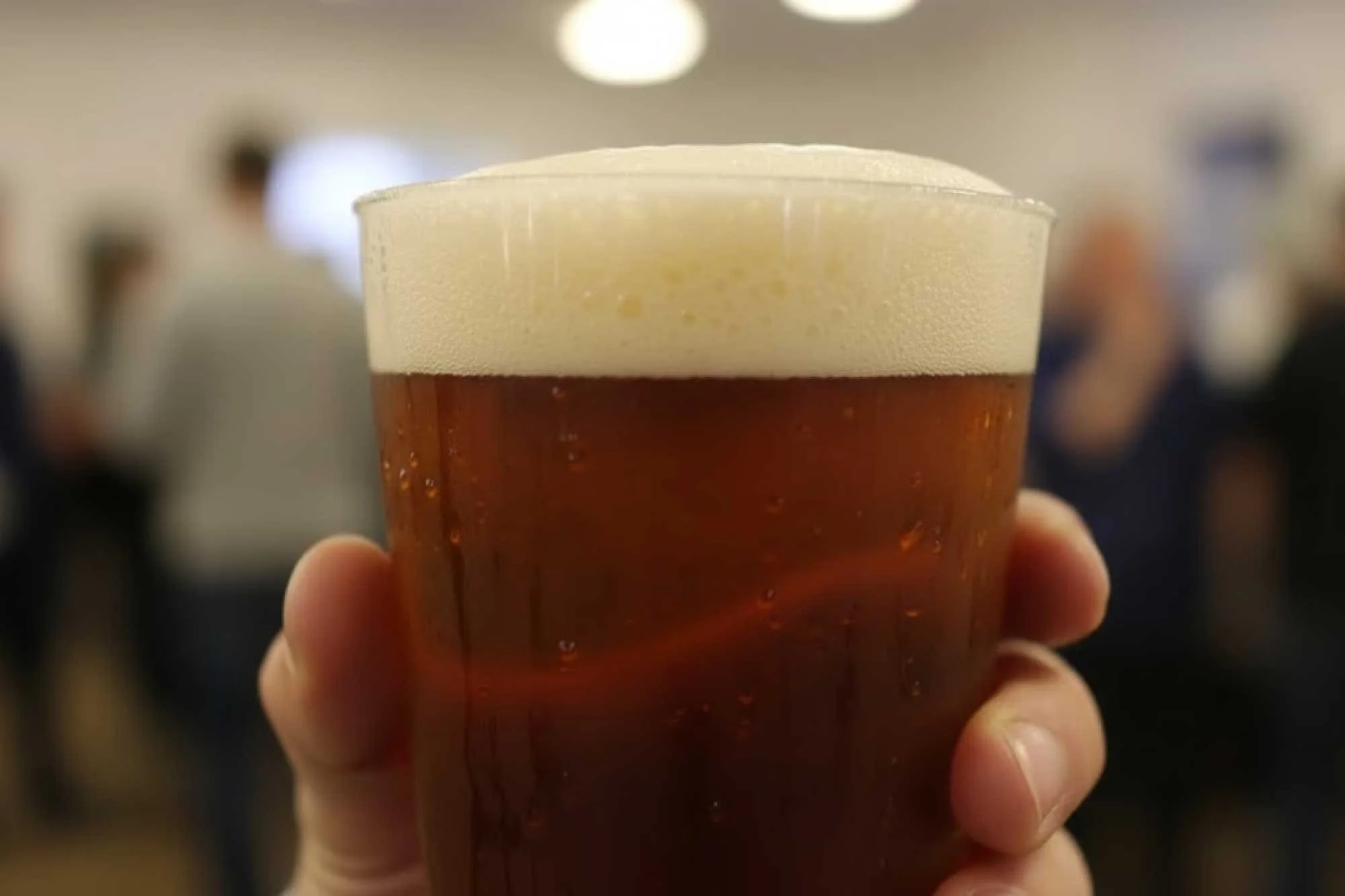 Real ale in a plastic pint glass at a beer & music festival