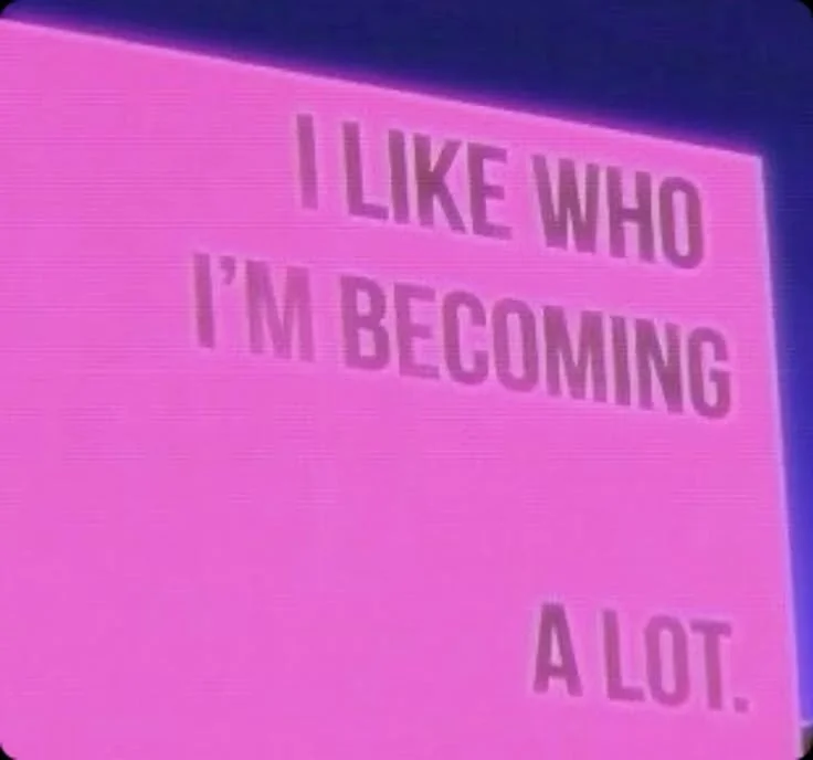Pink neon sign with the quote: "I LIKE WHO I'M BECOMING A LOT."