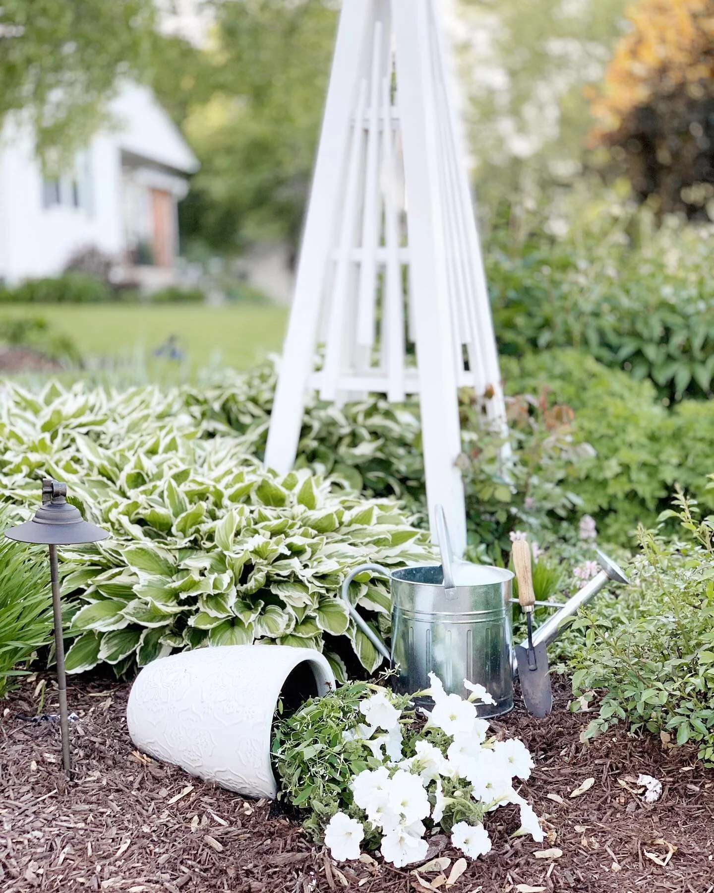 A new take on an old classic! Spilled pots that aren&rsquo;t whiskey barrels turned sideways... but modern glossy ceramic ones! And a pretty white obelisk as some outdoor decor that provides structure for a lovely and fragrant pink climbing rose&hell