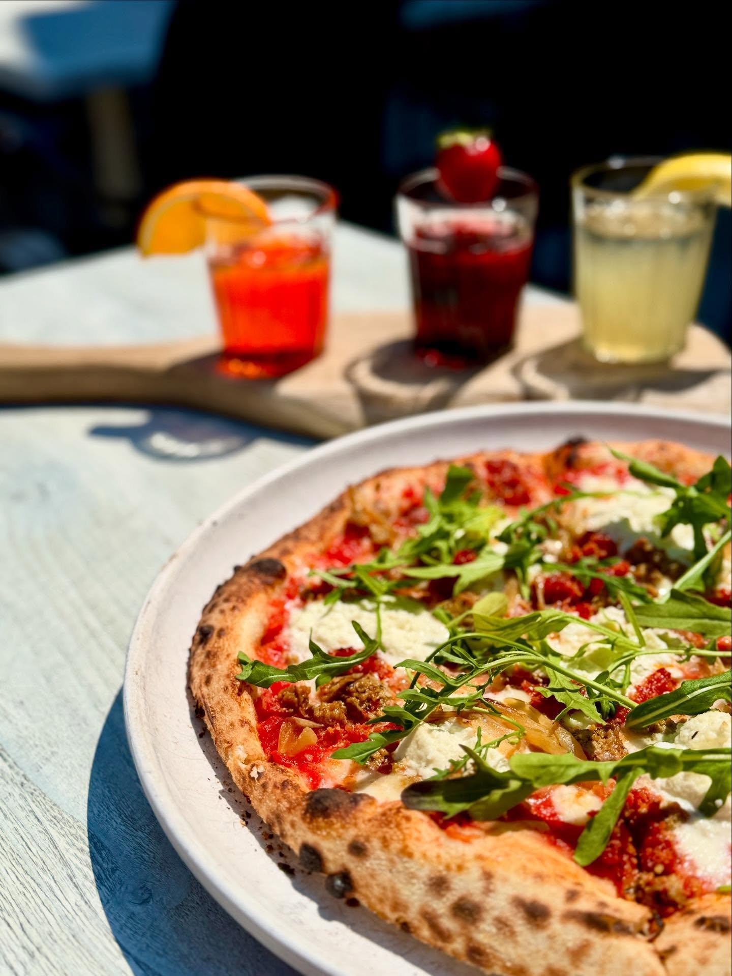 Here for a good time, not a long time.
This week&rsquo;s Pizza of the Week is summer heat on a plate: house-made Italian sausage, spicy &rsquo;nduja, creamy ricotta, caramelized onions, fresh arugula, and a melt of fior di latte mozzarella&mdash;all 