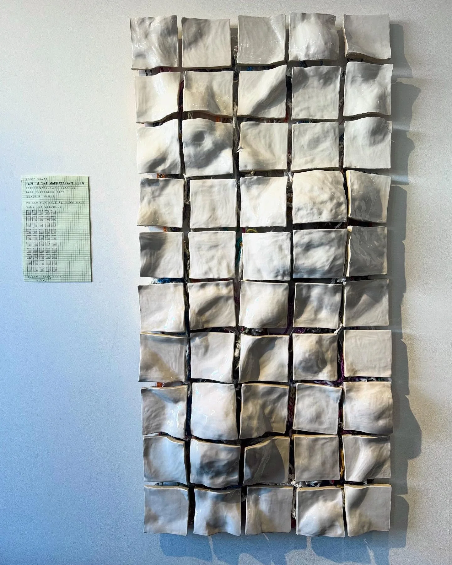 Push in the Marketplace, 2024
 
Installation: Earthenware, yarn scraps, plastic bags, discarded toys; Tiles sold individually at the 2024 Holland Project High Dez Marketplace on December 14th, 2024. Priced per tile; 6 participants.
 
48 x 24 x 4 inch