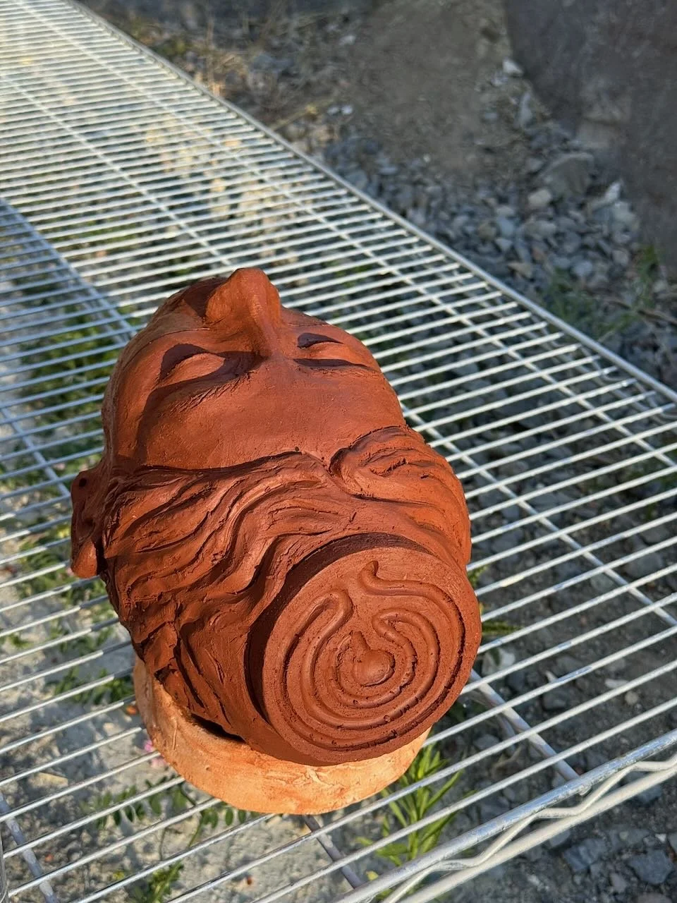 head sculpture on drying rack
