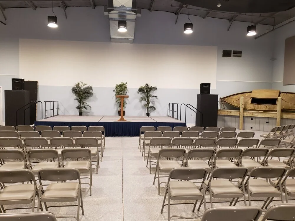 Meeting space with stage and folding chairs